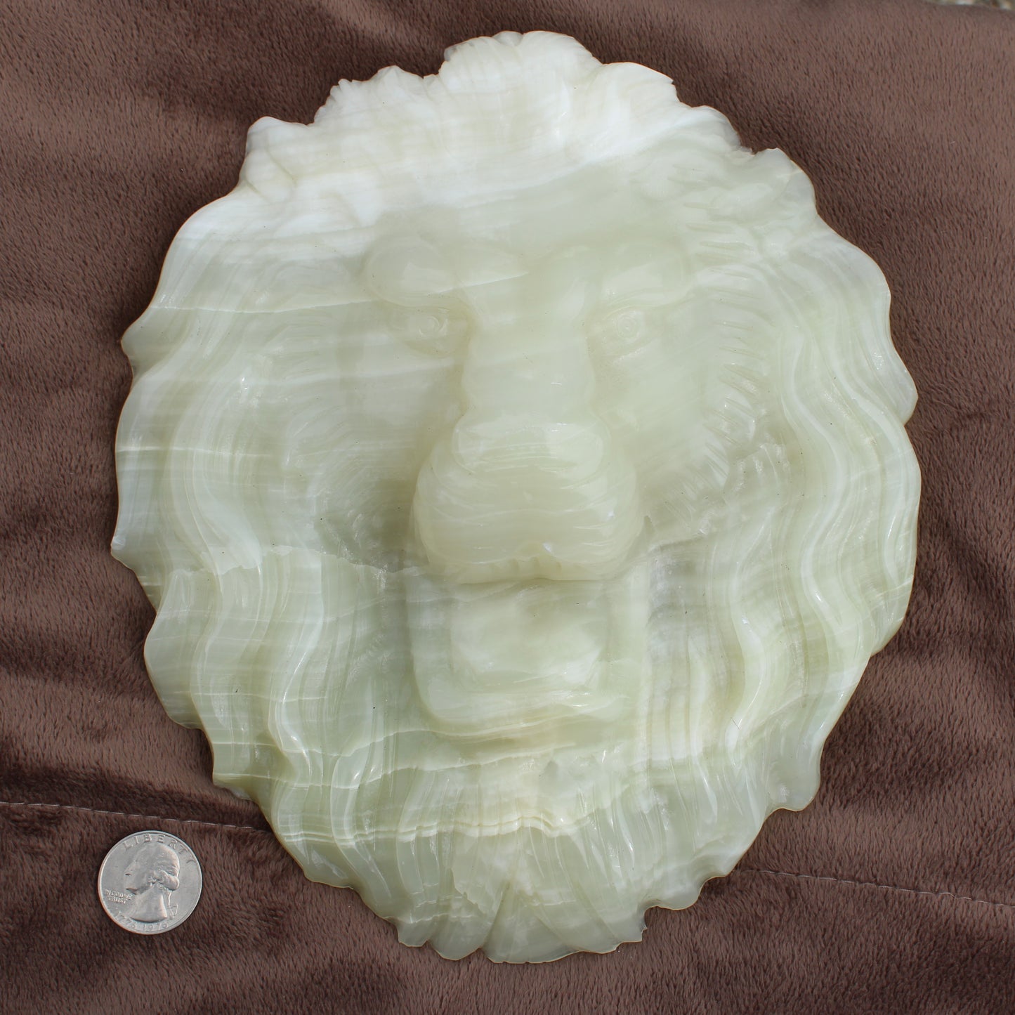 Afganistan Jade Lion head crystal Statement calcite carved detailed lion face next to a quarter for size