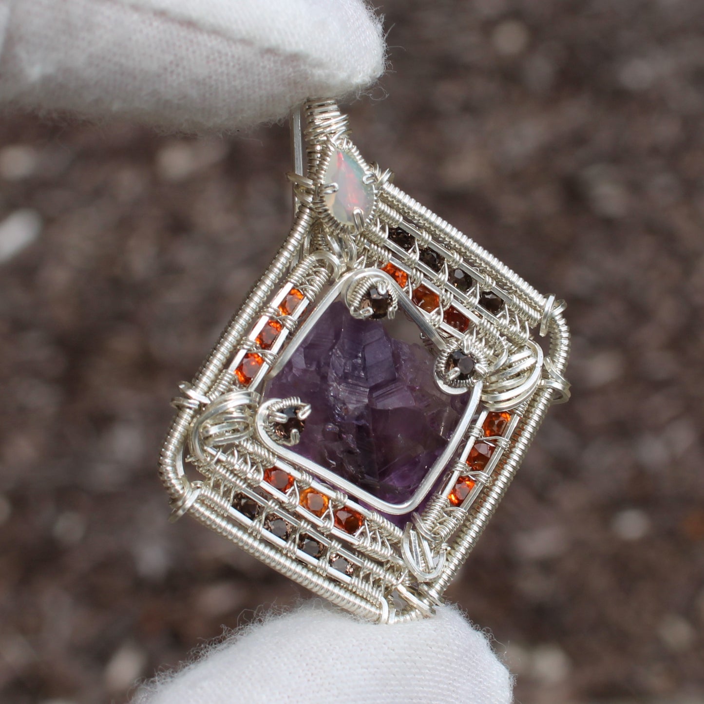 Handcrafted jewelry pendant featuring amethyst garnet opal silver wire wrapping by Different Branches LLC