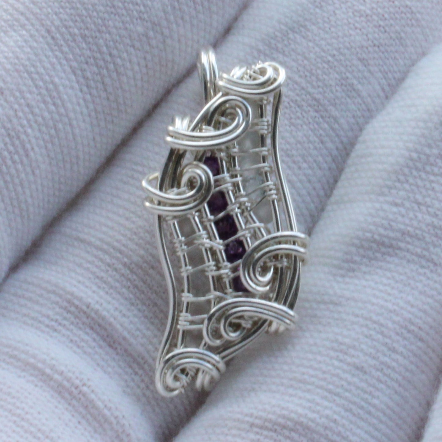 Sterling silver pendant featuring Amethyst and Moonstone in a unique wire design