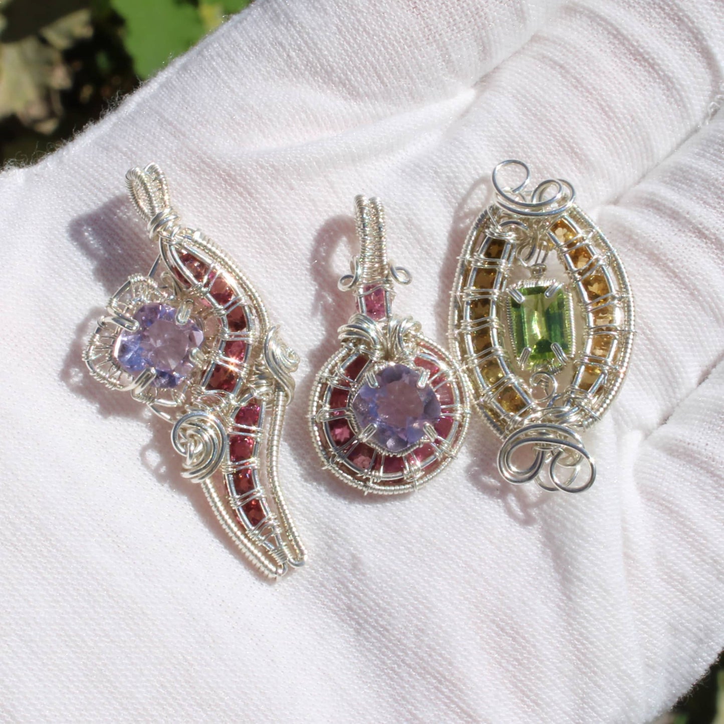 Elegant amethyst sterling silver pendants featuring pink tourmaline and intricate wire designs