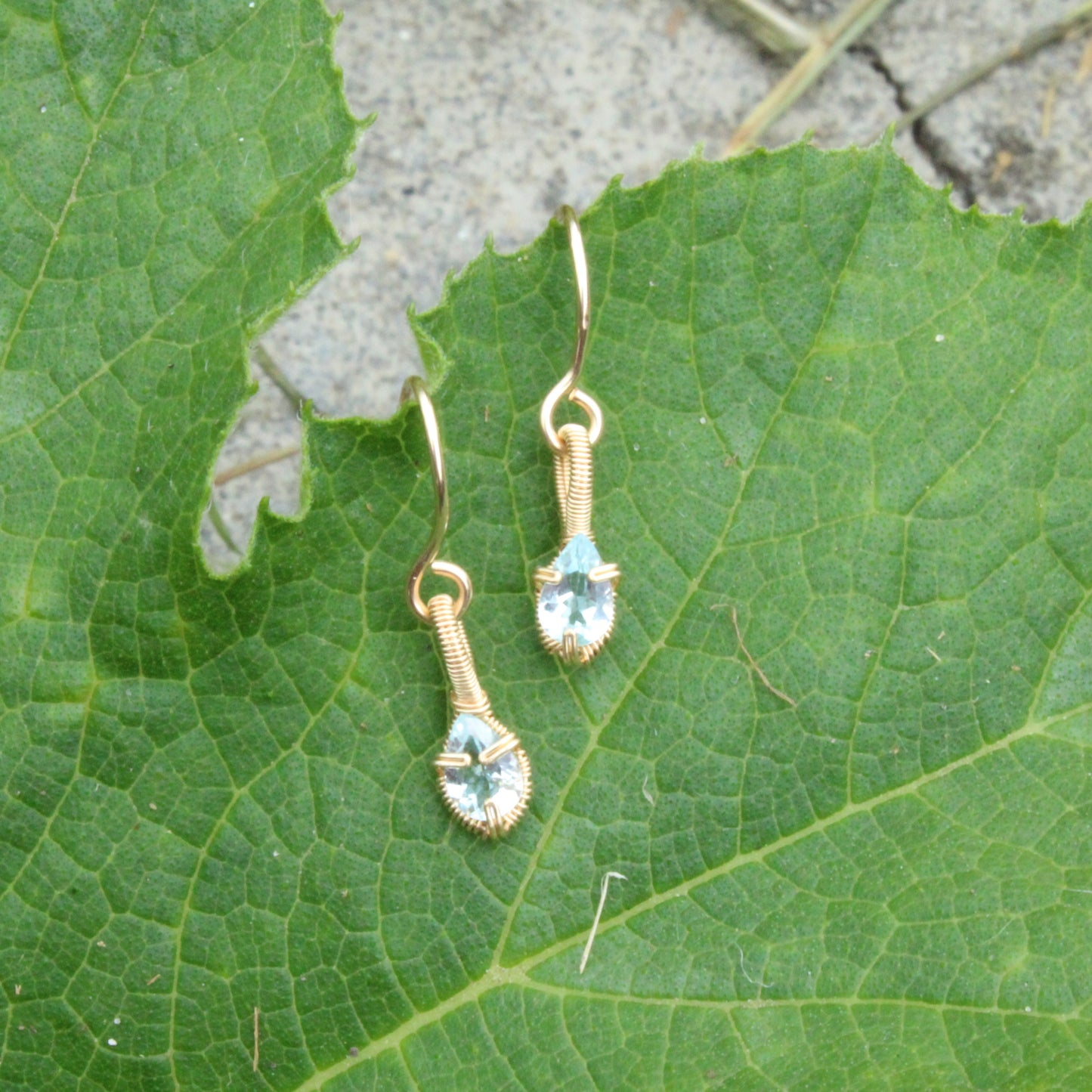 Aquamarine gold fill earrings delicately crafted with a floral design and set on green foliage