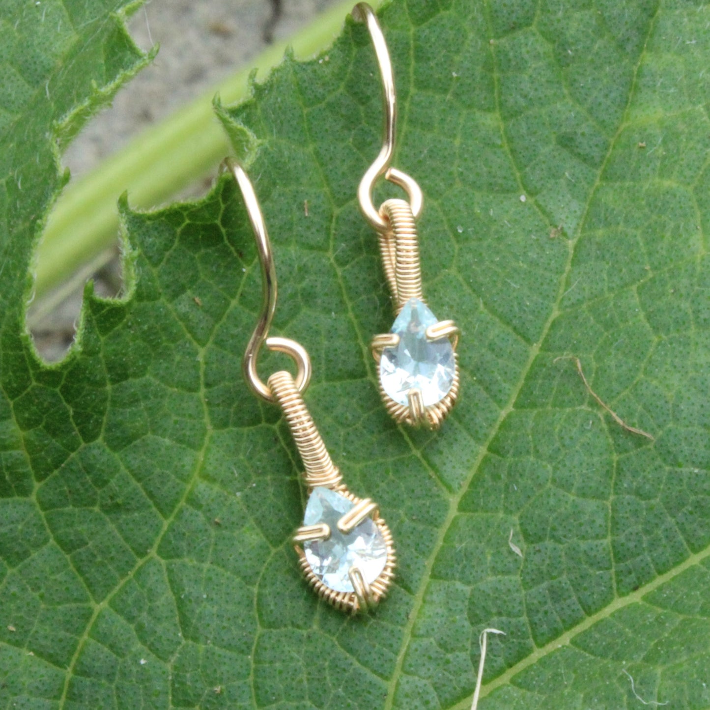 Aquamarine gold fill earrings featuring teardrop stones on a gold wire design