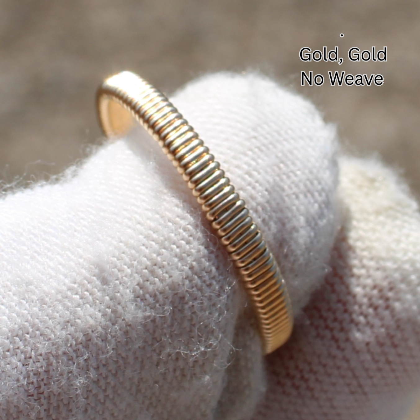 Gold ribbed coiled ring on white glove macro closeup showing texture and shine Made to order rings