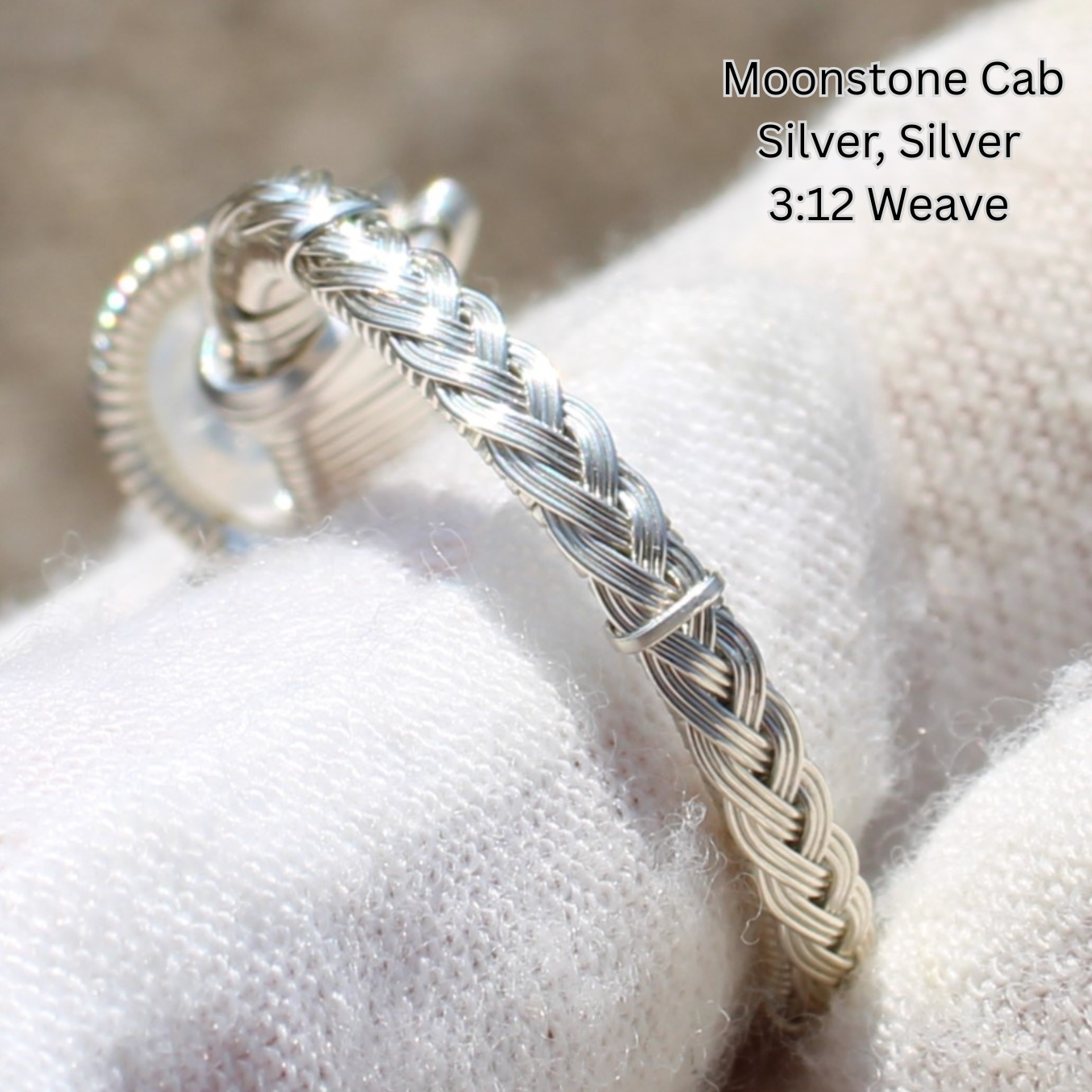 Silver braided wire ring with moonstone cabochon on white cloth Made to order rings by Different Branches LLC