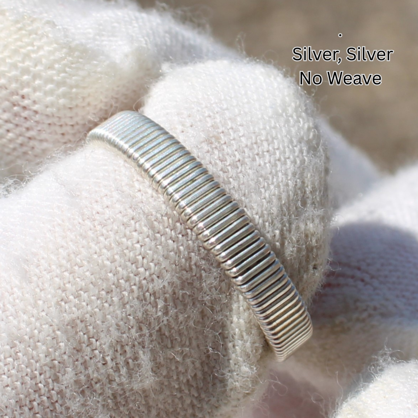 Silver ribbed band on gloved hand showcasing minimalist design and crystal detail Made to order rings by Different Branches LLC