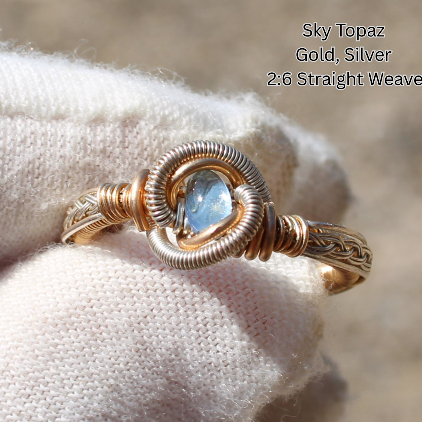 Different Branches LLC gold and silver wire wrapped ring with sky topaz cabochon on glove Made to order rings