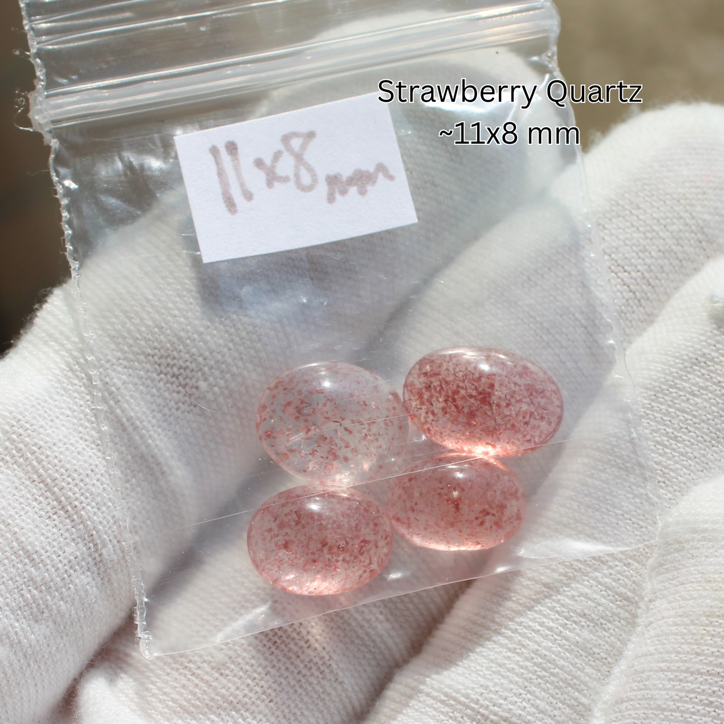 Strawberry quartz cabochons 11x8 mm in bag on gloved hand for Made to order rings