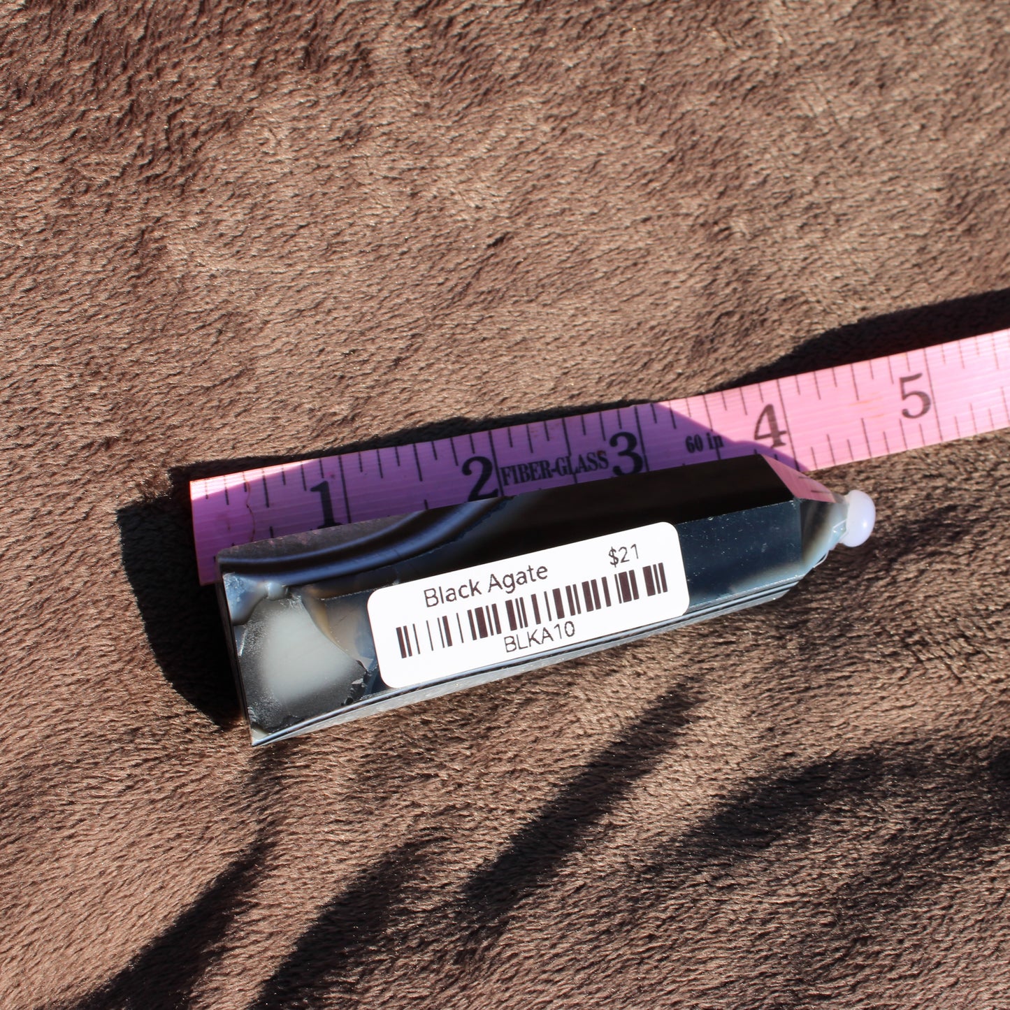 Black Agate Tower Collection on display with measuring tape for size reference