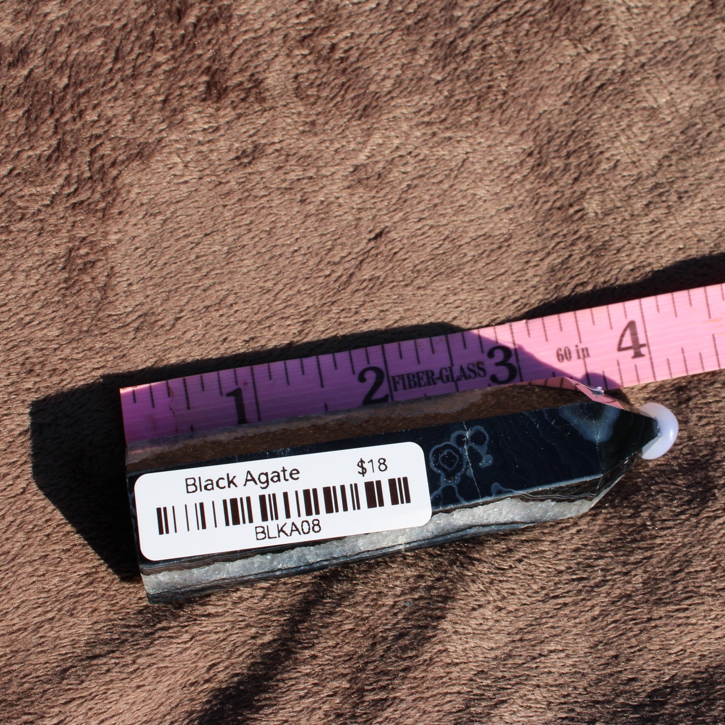 Black Agate Tower Collection displaying a polished black agate crystal with a measurement ruler for size reference