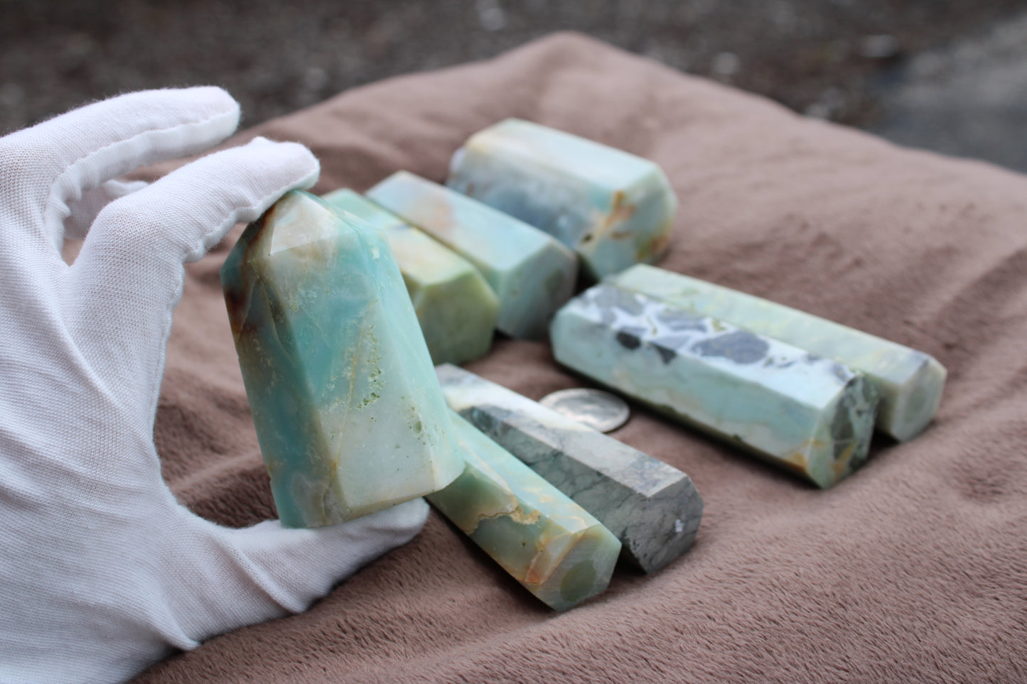 Handheld Caribbean Calcite towers in various colors and shapes on a soft cloth