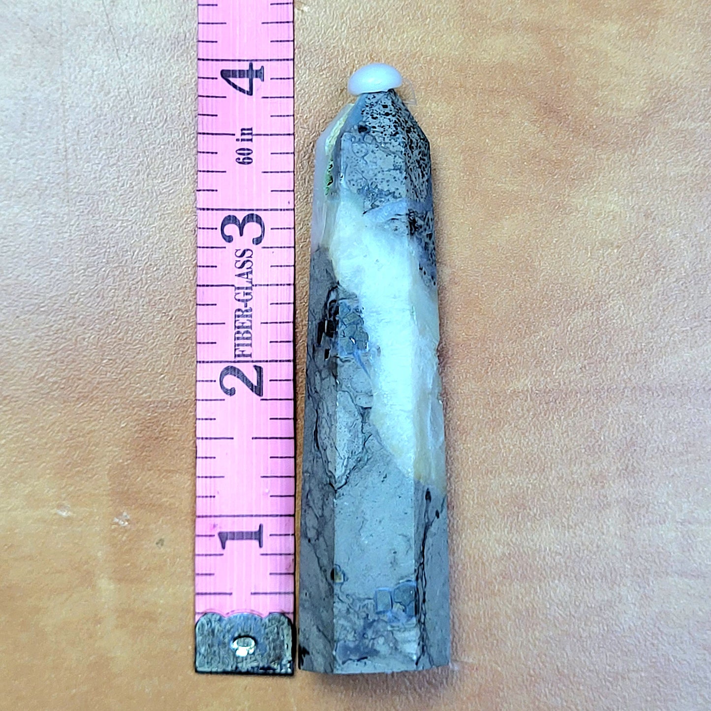 Caribbean Calcite towers in a natural finish next to a measuring ruler for size reference