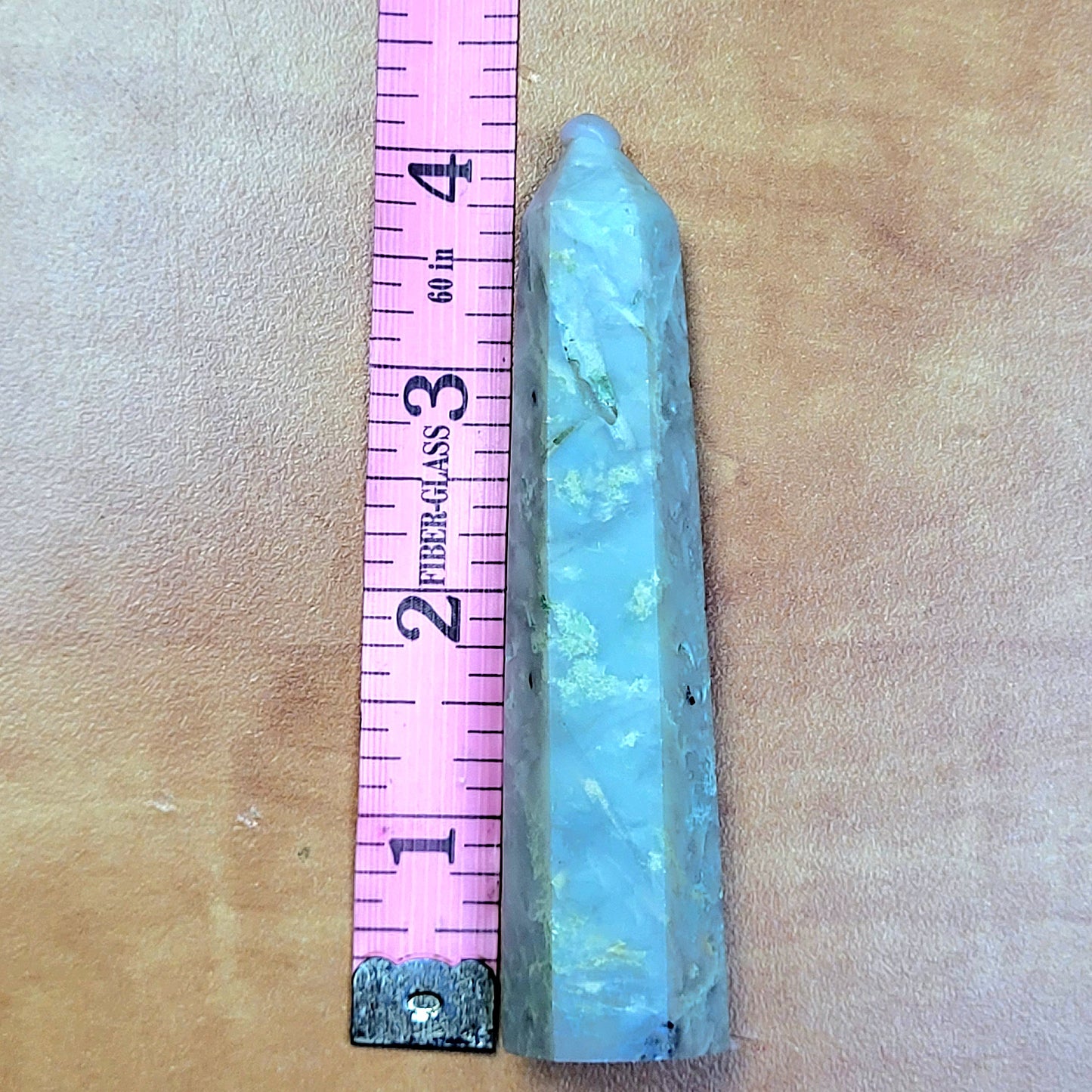 Caribbean Calcite towers displayed next to a ruler for size reference against a textured background