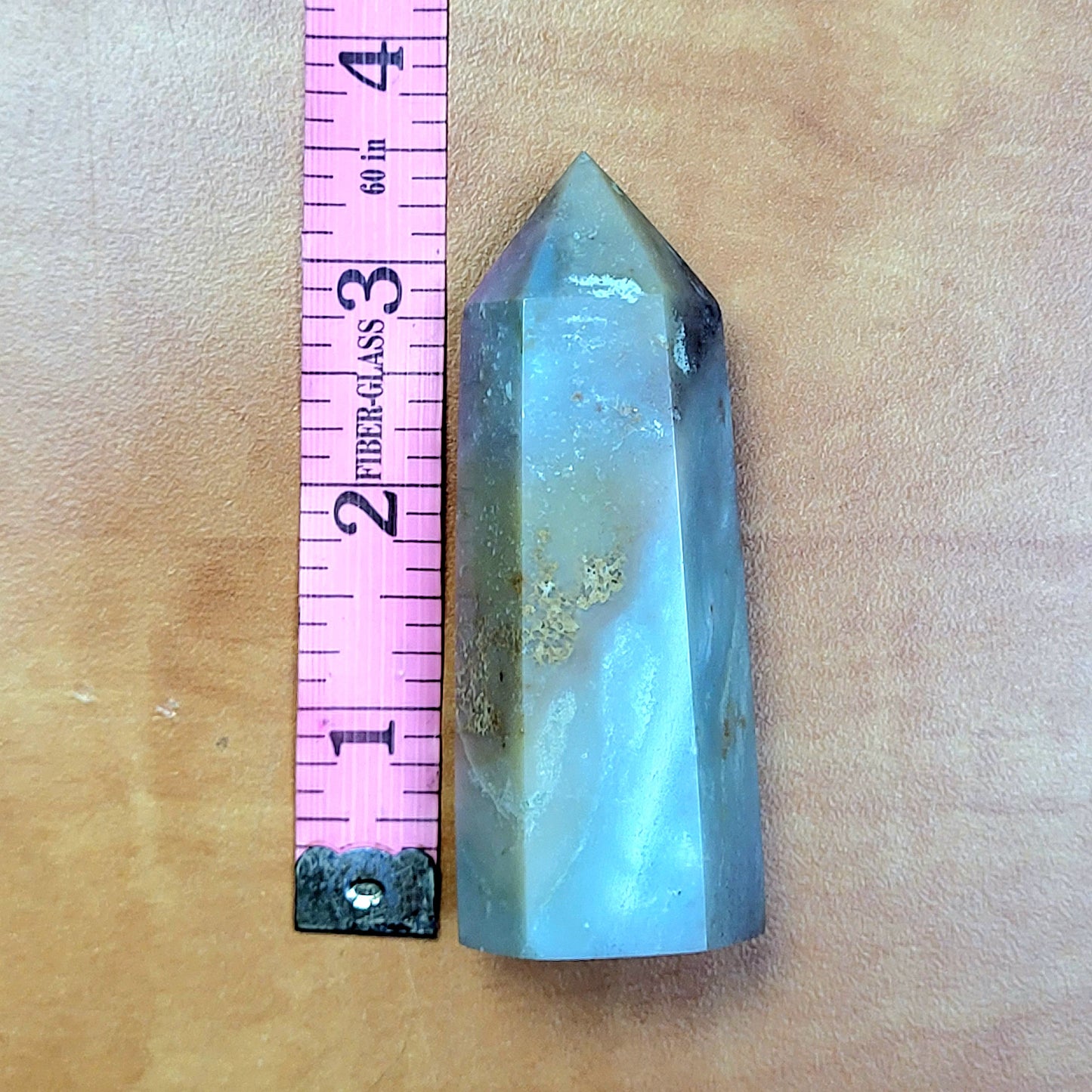 Caribbean Calcite towers in a polished crystal form next to a ruler for size reference