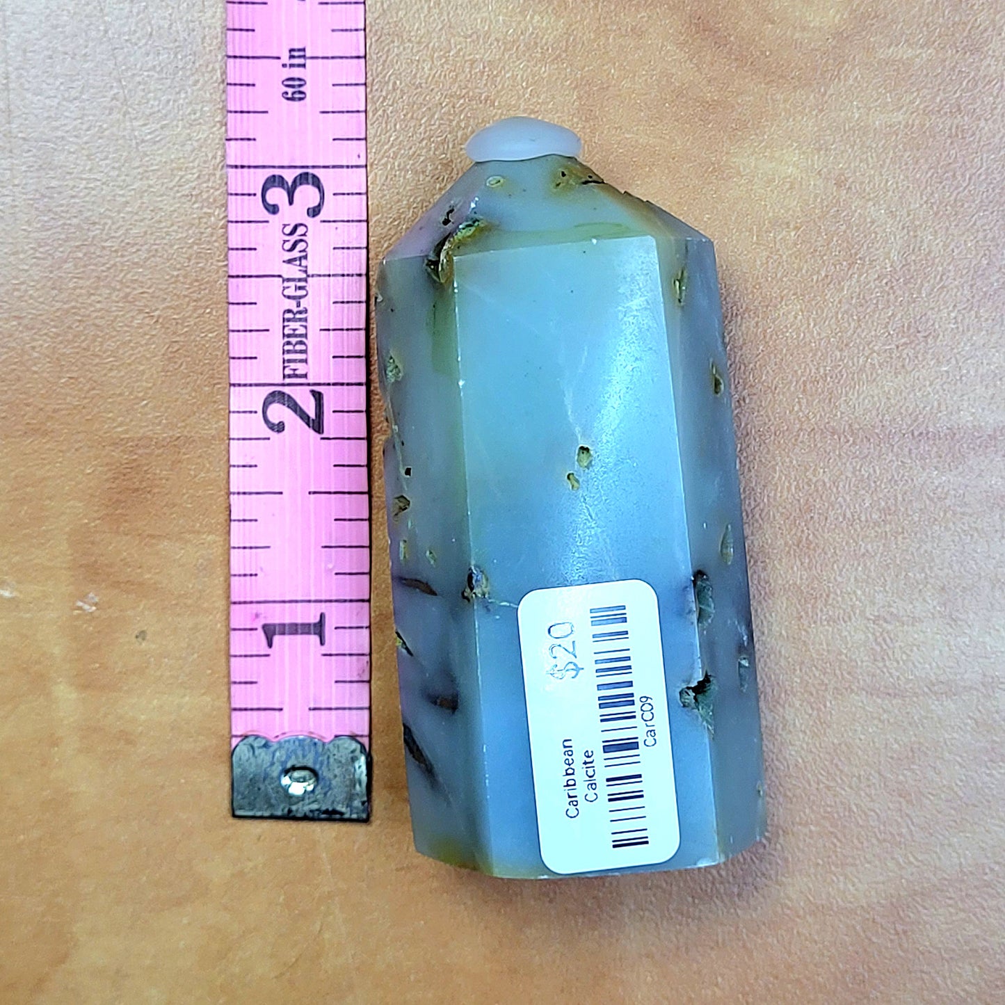 Caribbean Calcite towers displayed beside a ruler for size reference, showcasing unique pastel colors