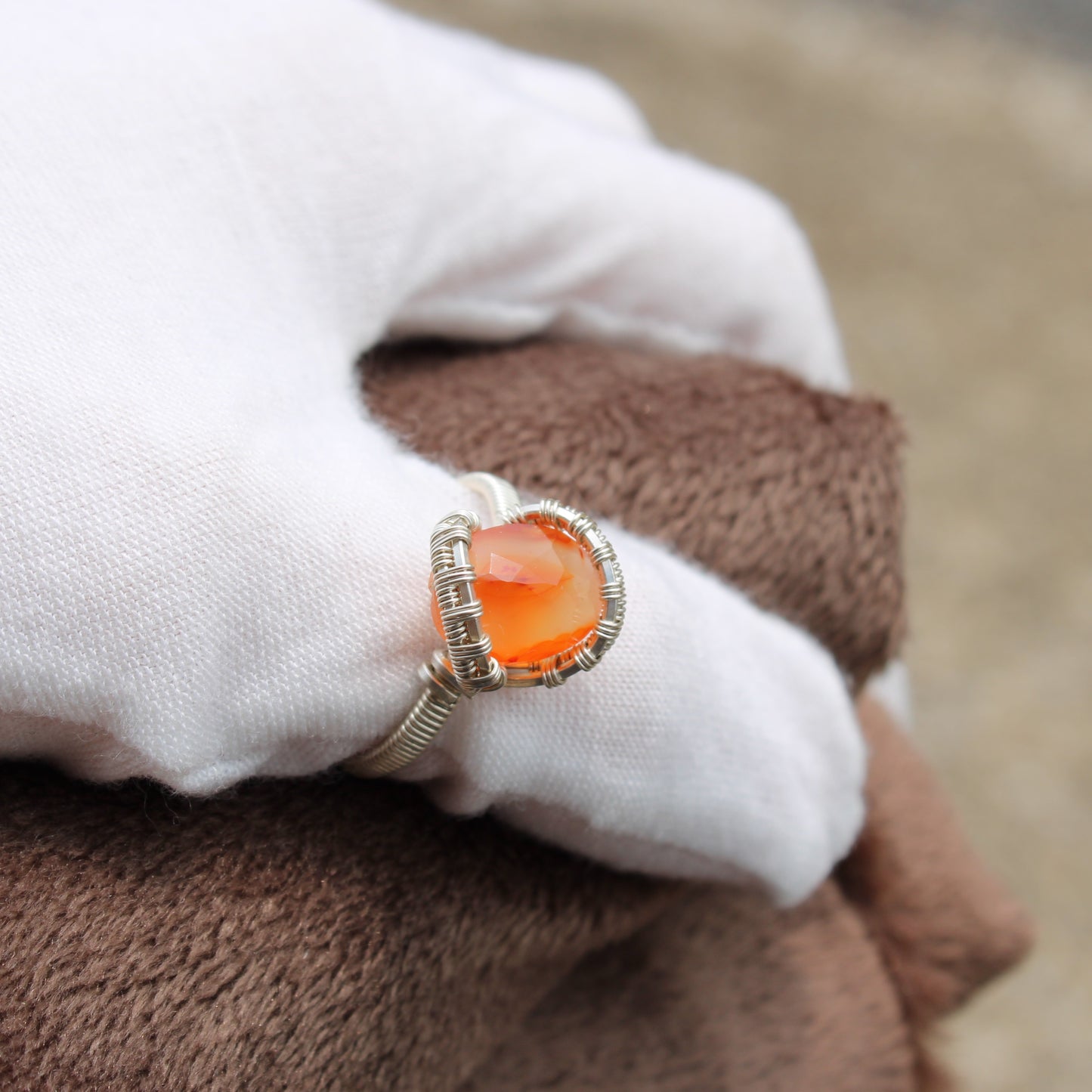 Elegant silver wire-wrapped carnelian ring size 9 showcasing a vibrant orange gemstone