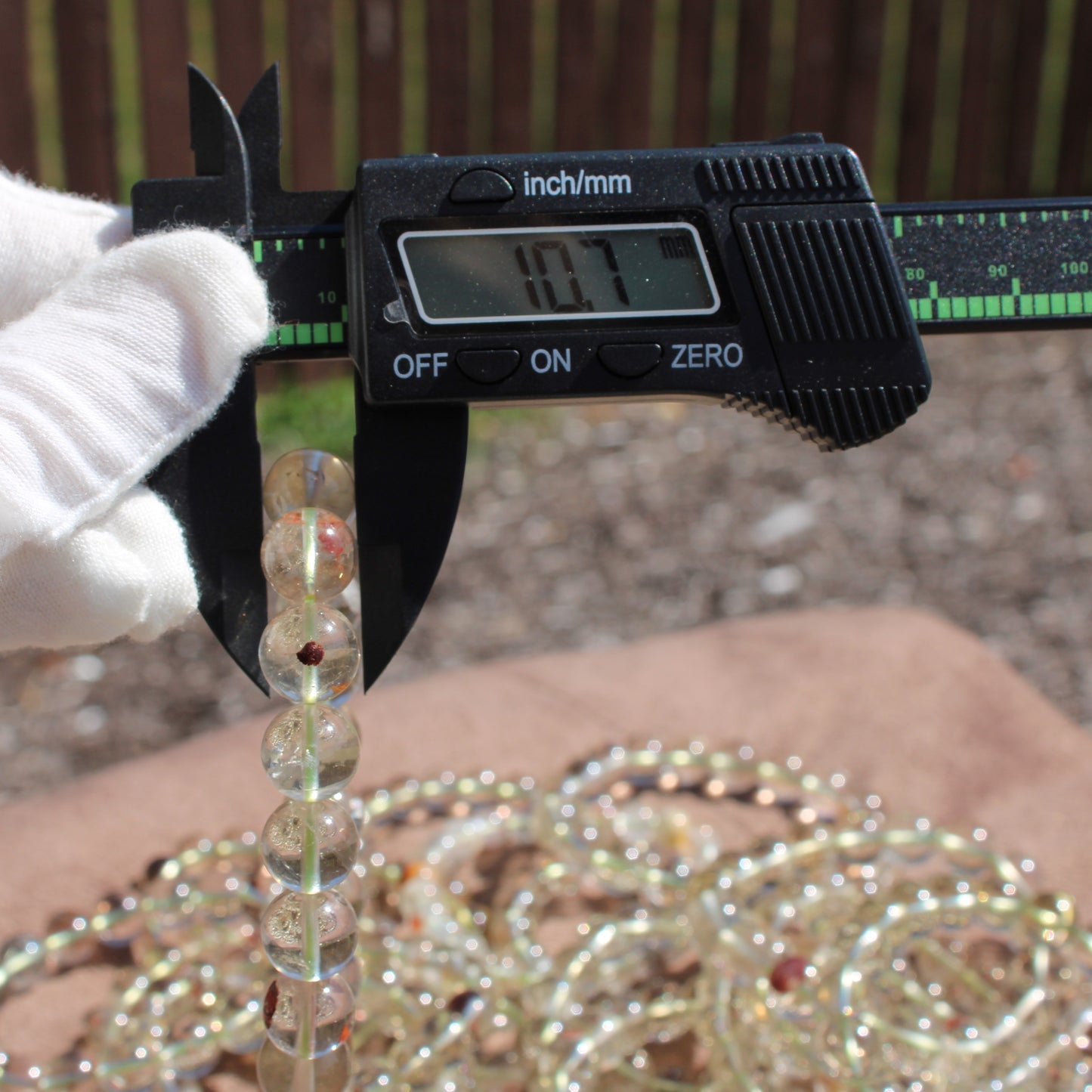 Measuring the size of a Clear Quartz Bracelet using calipers for accurate fit details