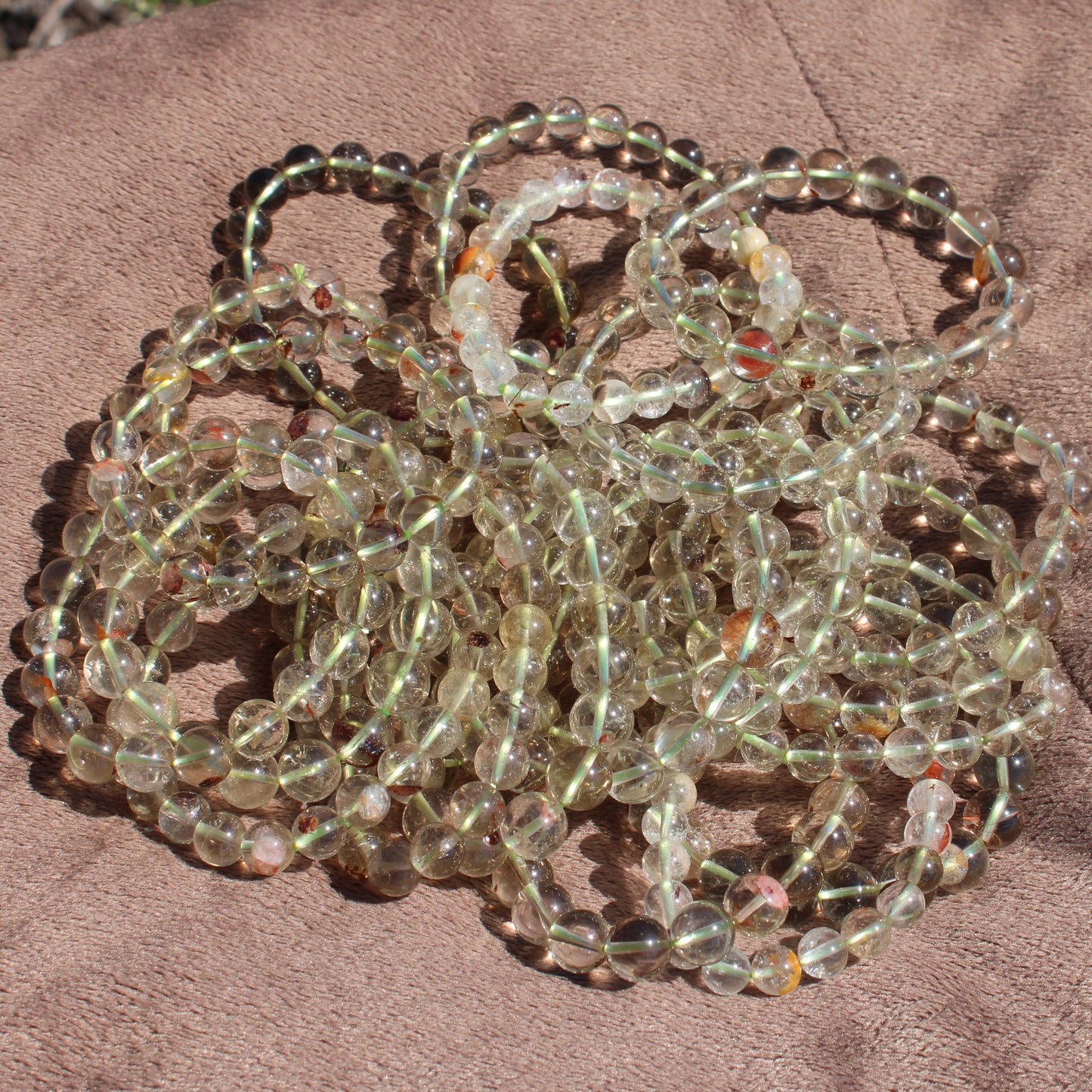 Multiple Clear Quartz Bracelets arranged together showcasing their natural shine and clarity
