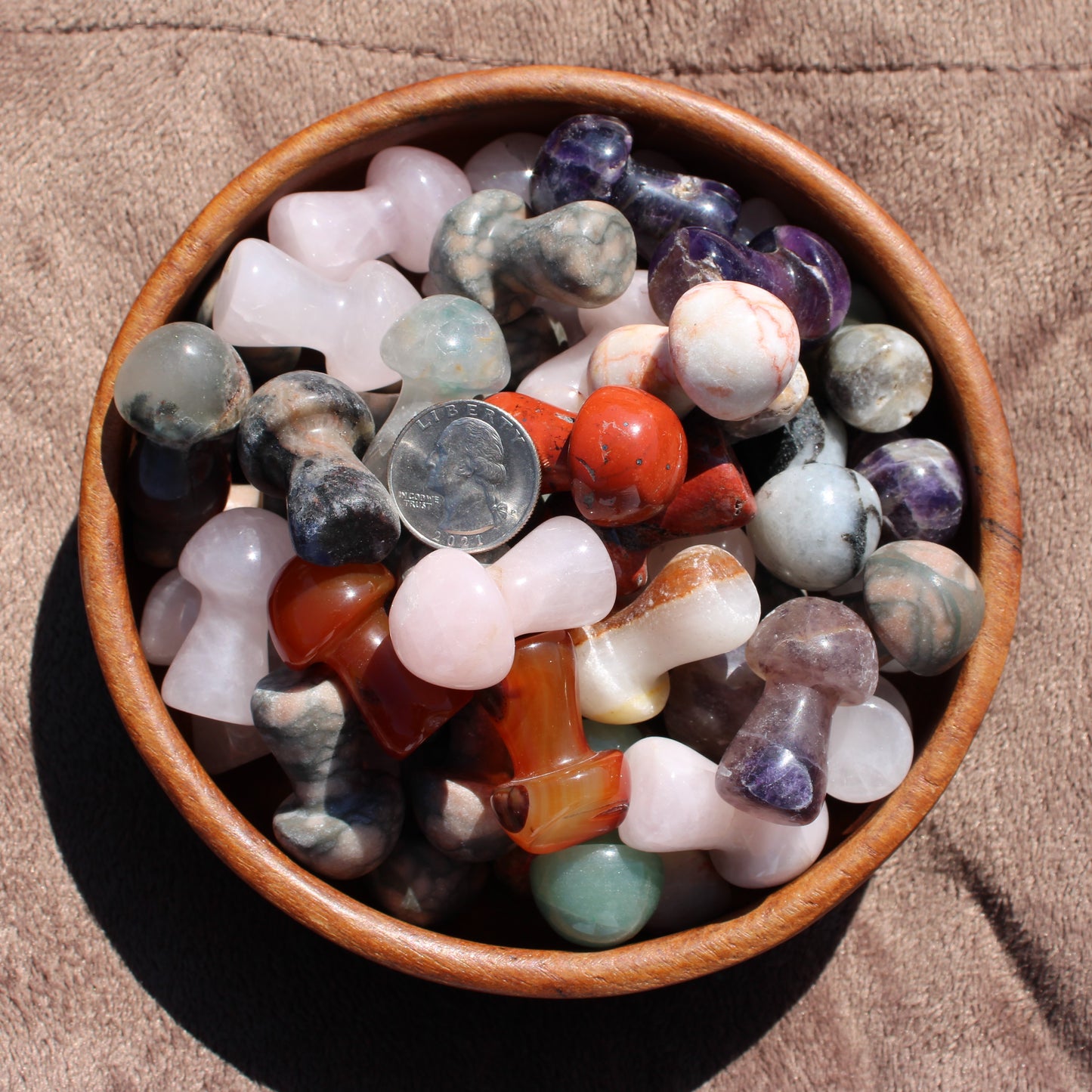 Assorted Crystal Mushroom Carving pieces in a wooden bowl showcasing various colors and shapes