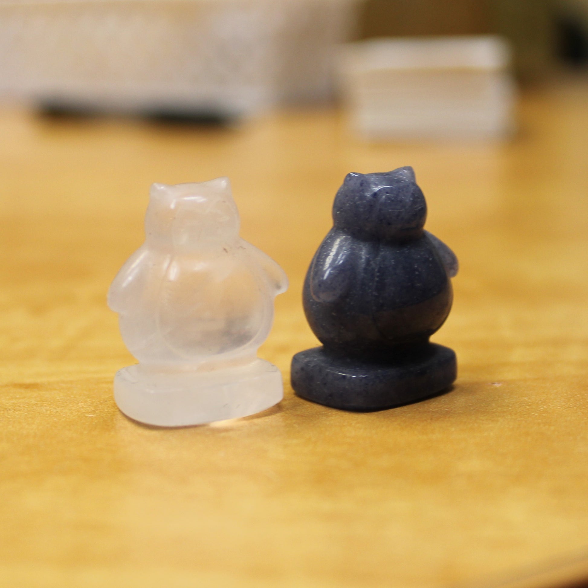 Crystal Pokemon gift set featuring clear and dark blue Snorlax figures on wooden surface