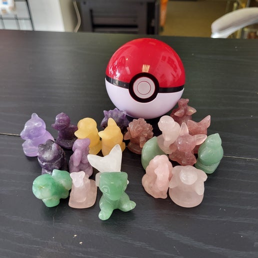 Crystal Pokémon gift set with colorful carved crystal Pokémon figures and a red and white Poké Ball