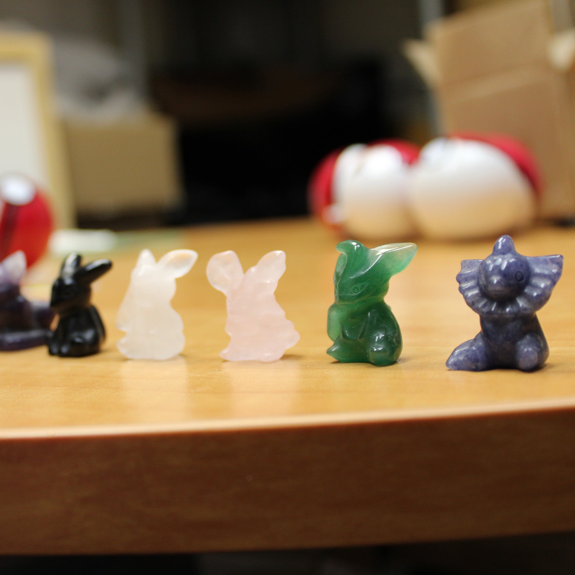 Crystal pokemon gift set featuring small colorful crystal Pokemon figurines displayed on a wooden surface
