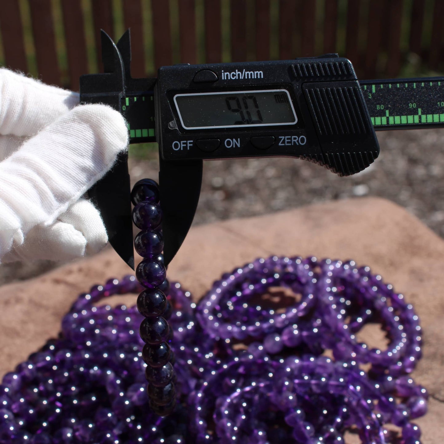 Measuring Deep Purple Amethyst Bracelet with a ruler for accurate size assessment