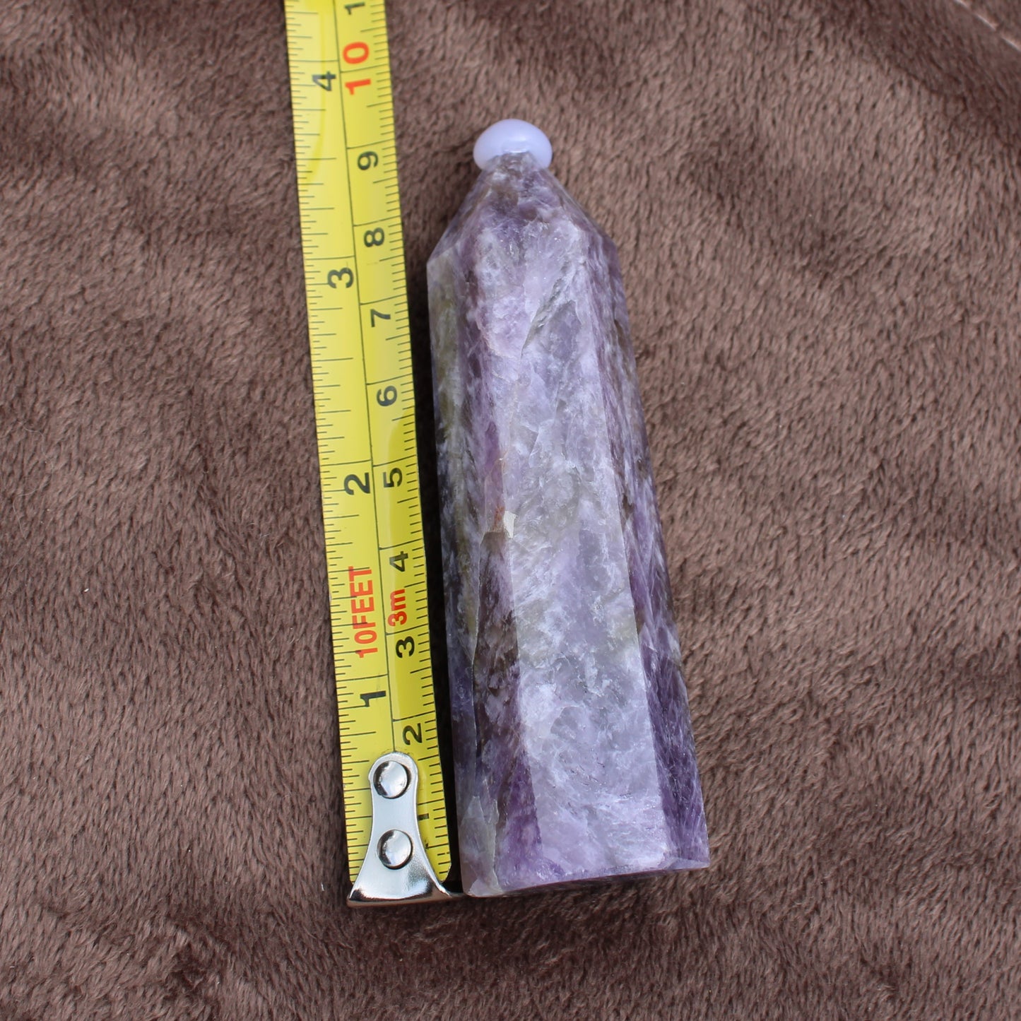 Dream Amethyst Tower crystal measuring about 6 inches with purple and white natural patterns