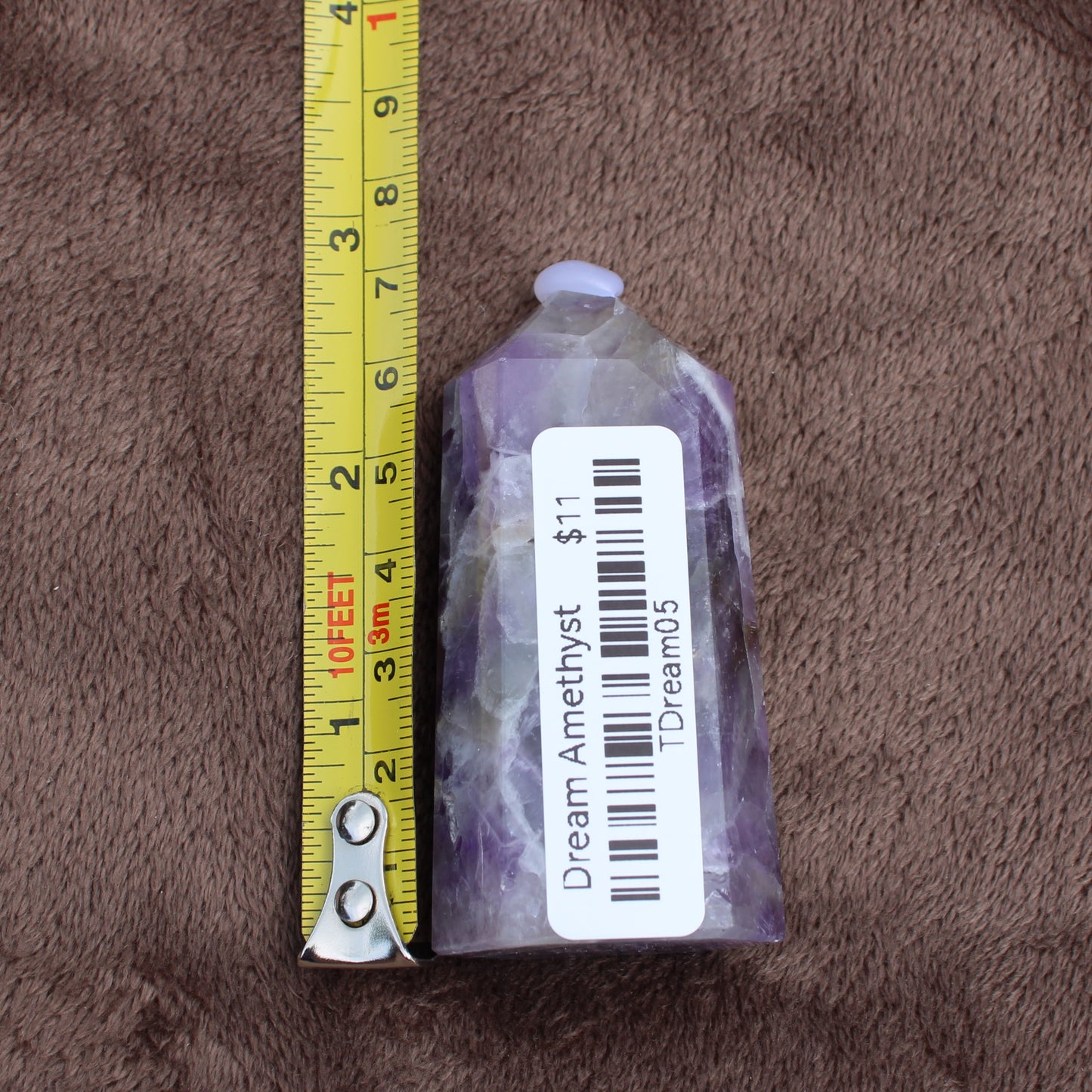 Dream Amethyst Tower crystal measuring about 3 inches tall with purple and white hues