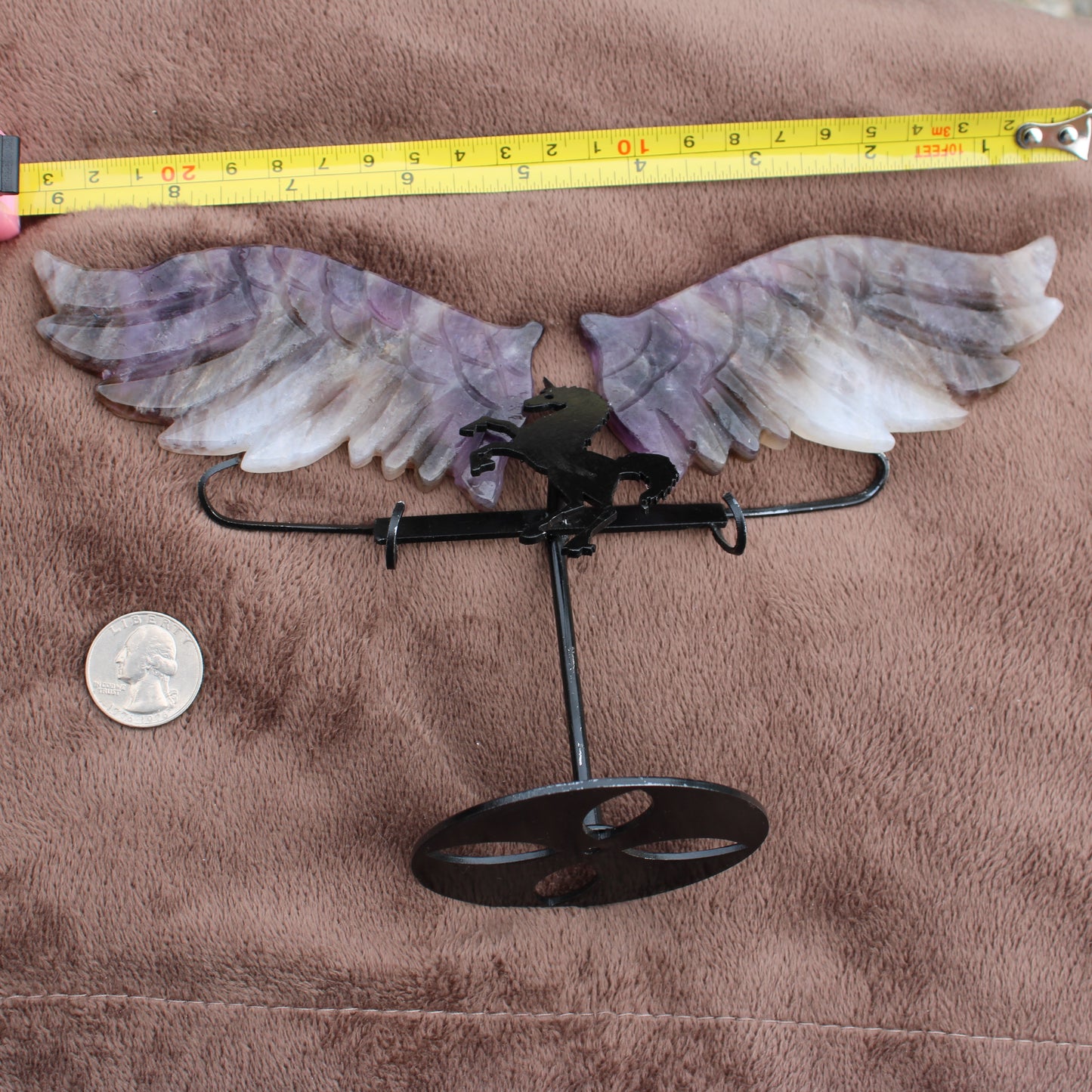 Dream Amethyst Unicorn Wings crystal decoration with metal stand showing size next to quarter and tape measure