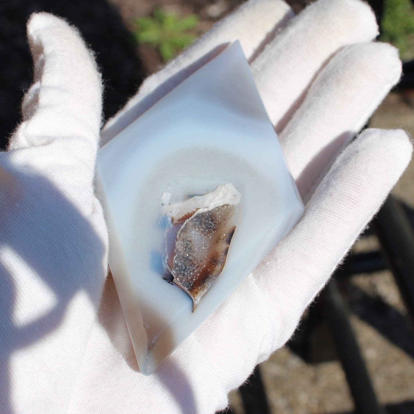 Druzy Agate Diamond held in a gloved hand showcasing its unique crystal formation and natural beauty