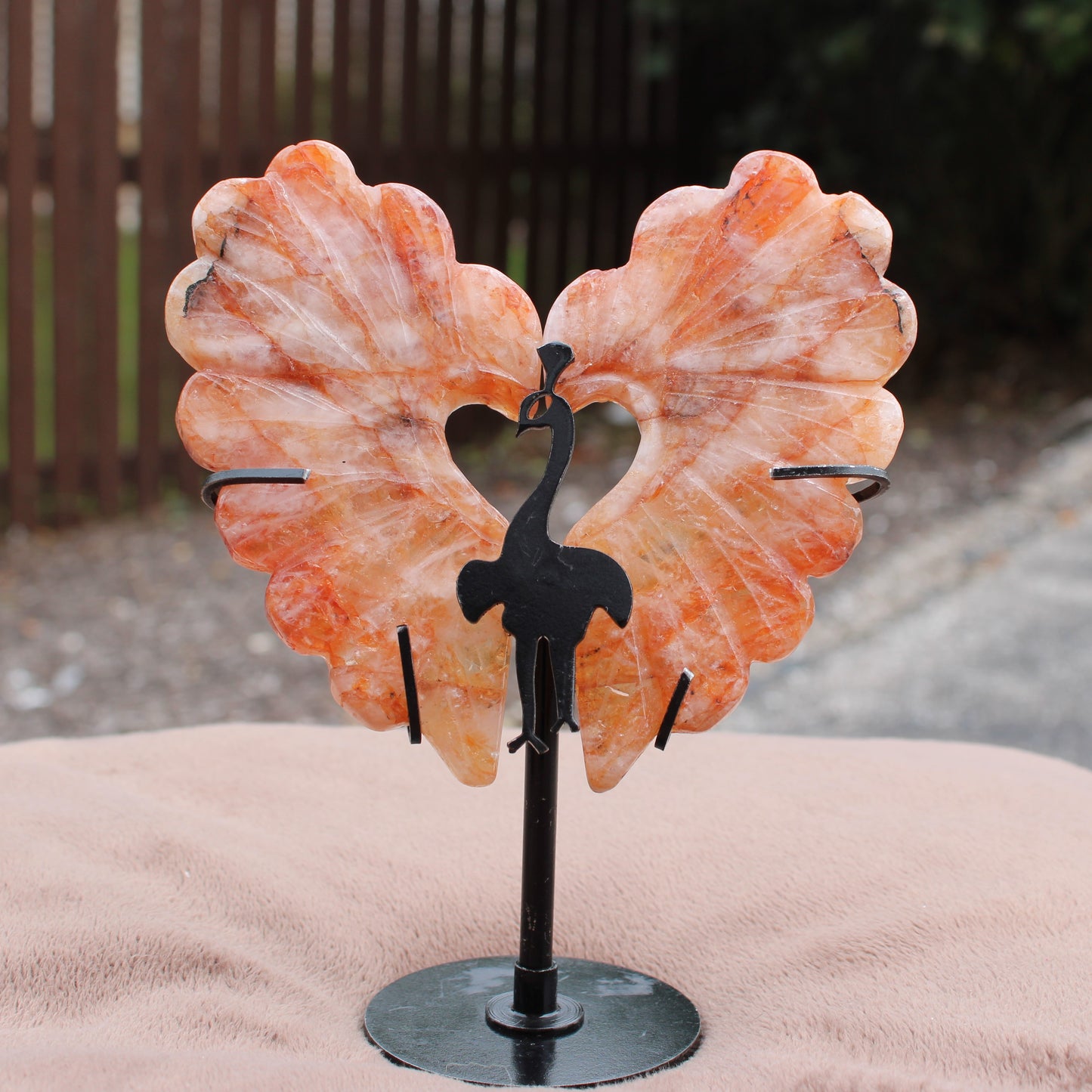 Fire Quartz Peacock Wings crystal on metal stand by Different Branches LLC with orange and white hues