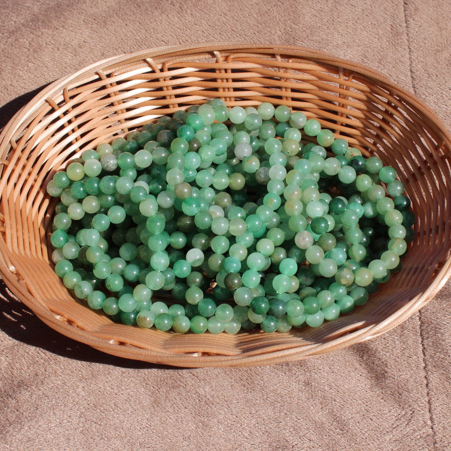 Green Aventurine Bracelet displayed in a woven basket for natural crystal jewelry enthusiasts