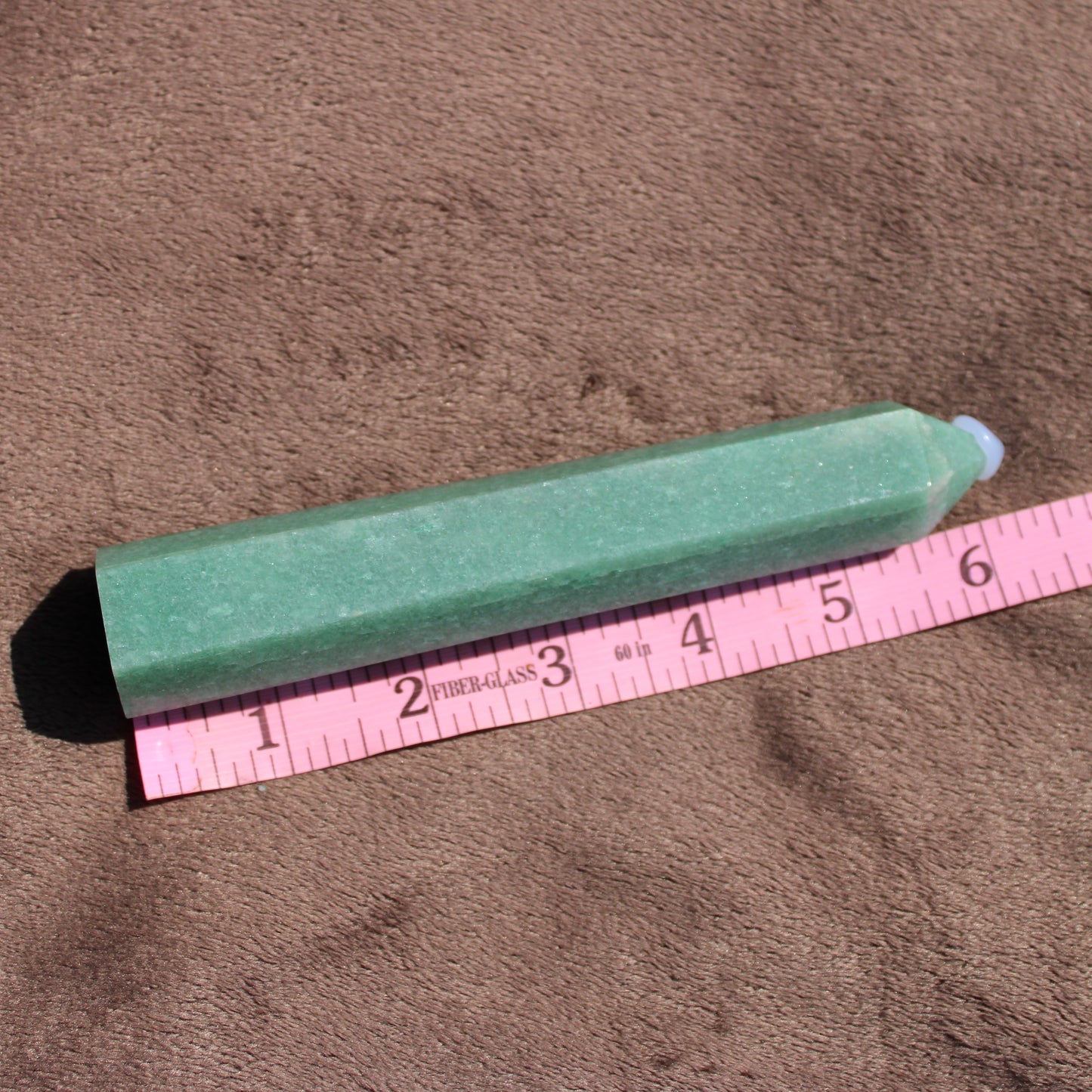 Green Aventurine tower with a polished finish, measuring approximately 4 inches long