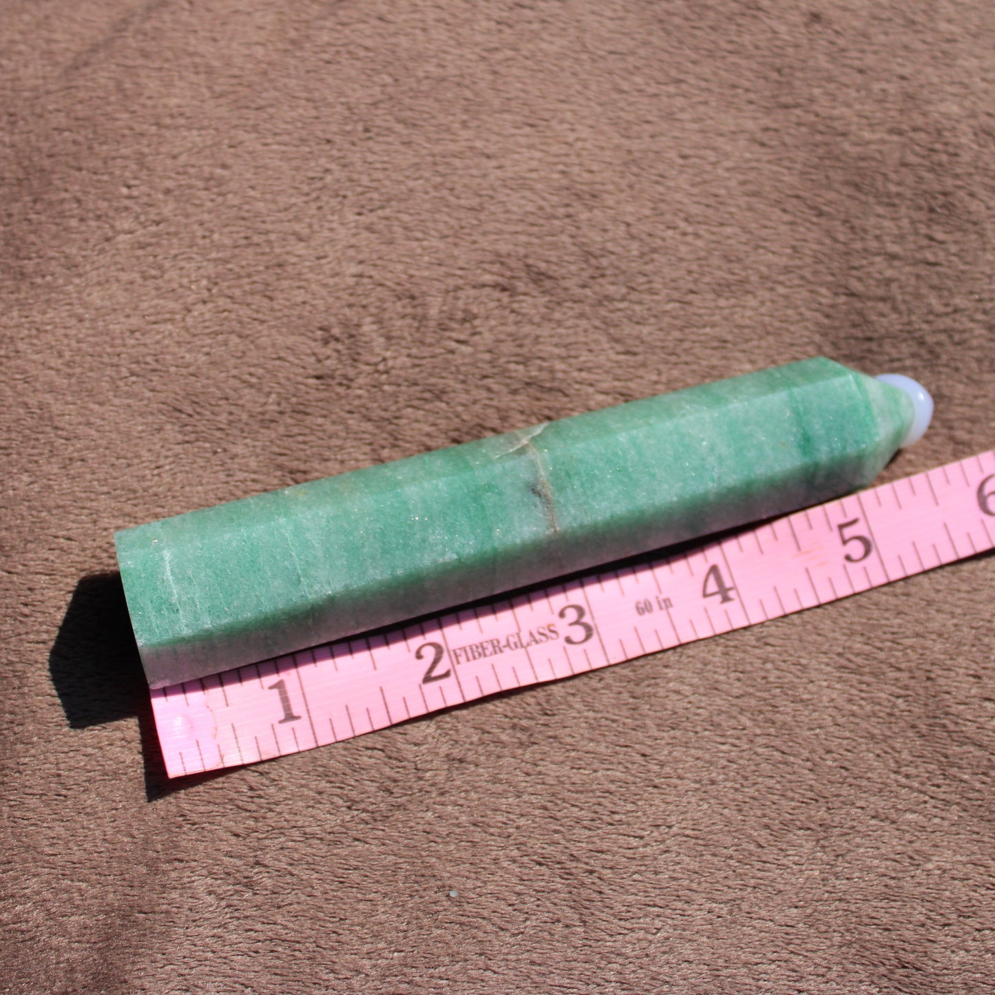 Green Aventurine tower with tapered design, measuring approximately six inches long on a ruler