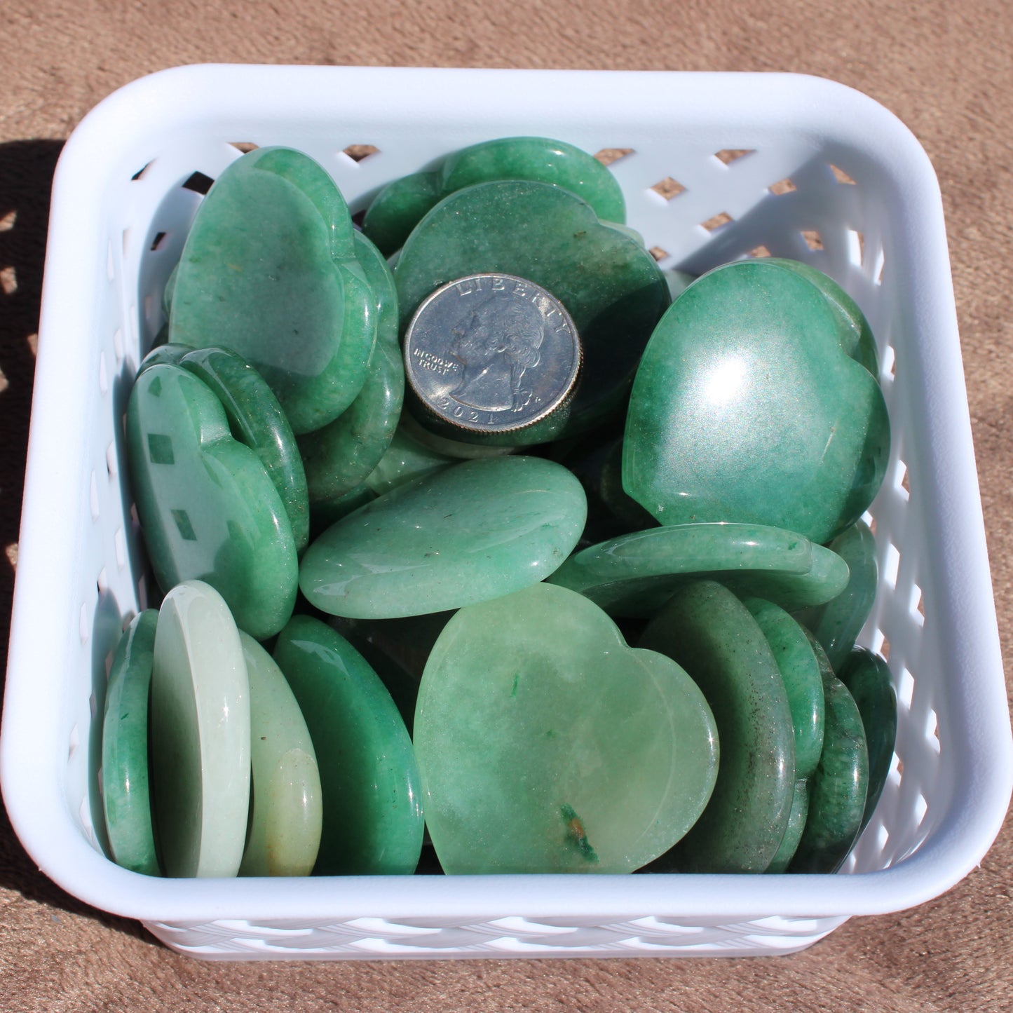 Basket of Green Aventurine Worry Stones in heart shapes, ideal for relaxation and stress relief