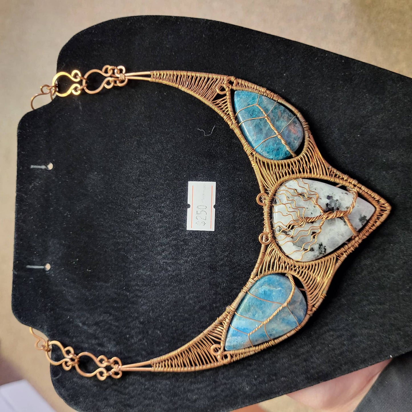 Rainbow Moonstone and blue apatite copper bib necklace with intricate wire detailing and elegant design