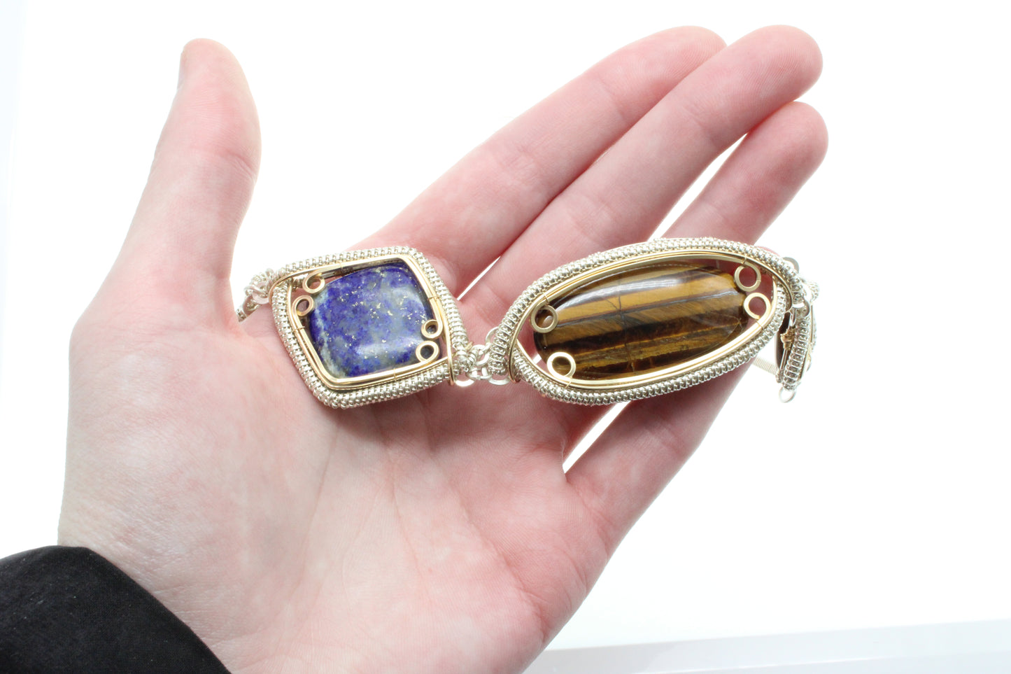 Handcrafted sterling silver necklace featuring a lapis lazuli and tiger's eye design with intricate settings