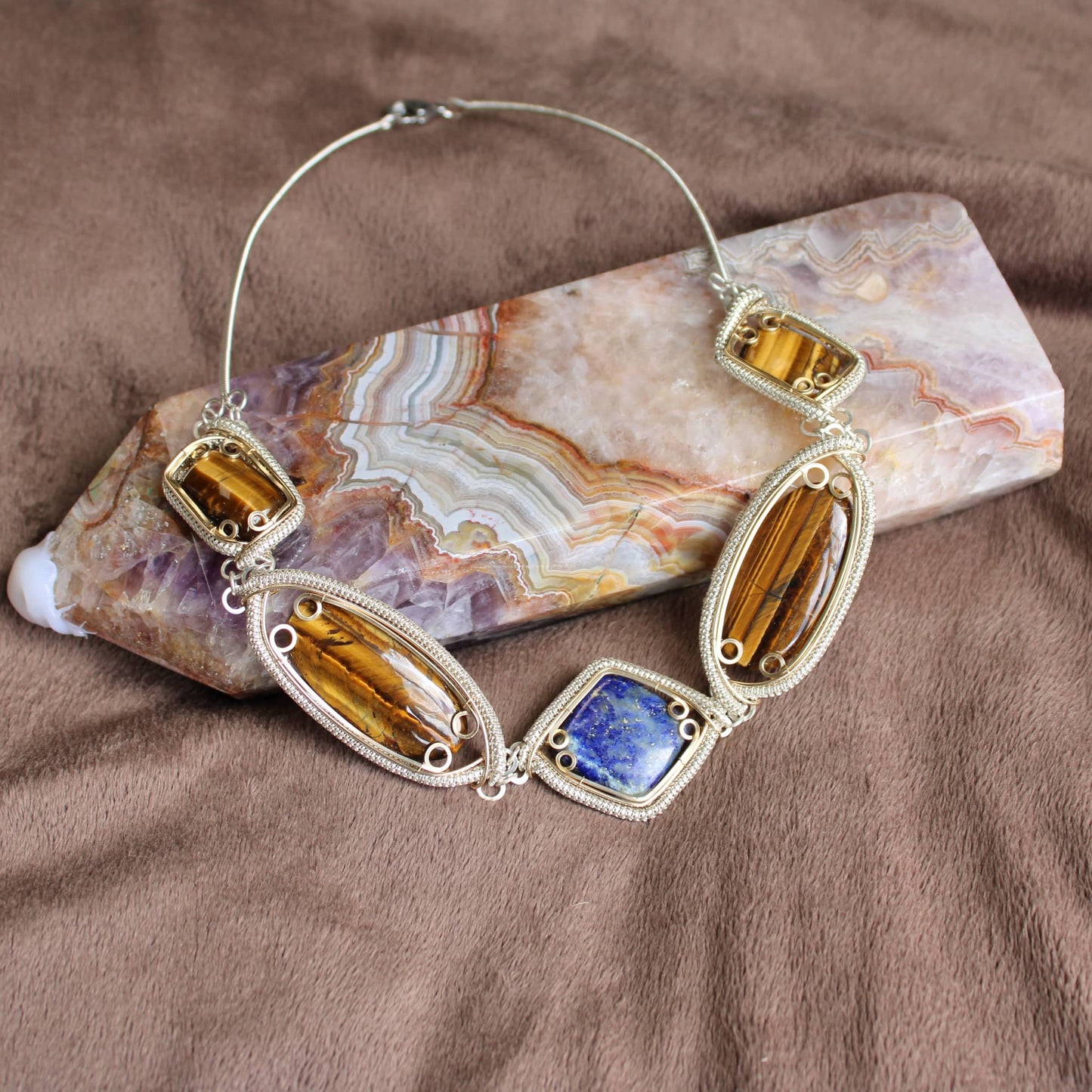 Handcrafted sterling silver necklace with tiger's eye and lapis lazuli gemstones, perfect for unique style