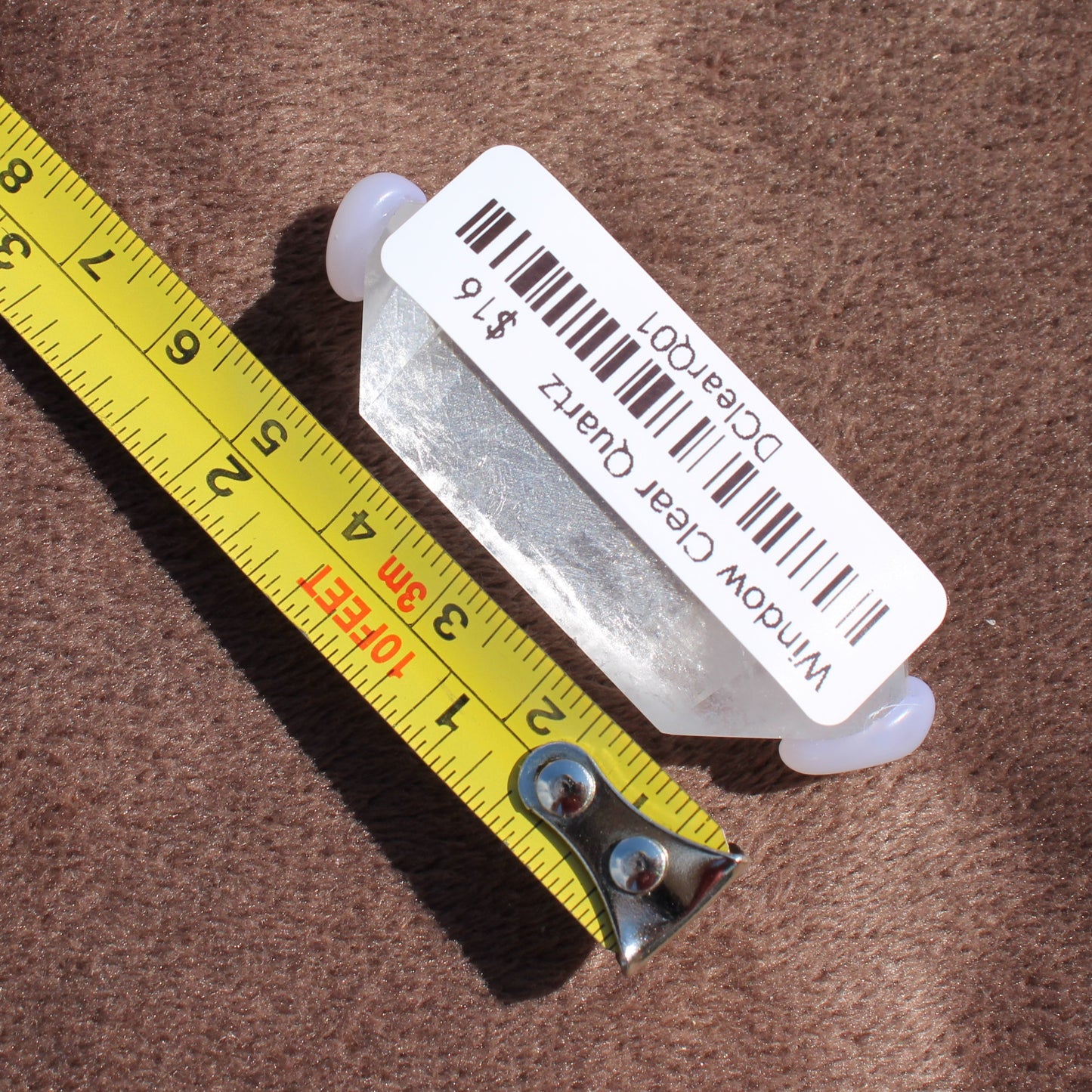 High Quality Clear Quartz crystal from Different Branches LLC with measuring tape showing size
