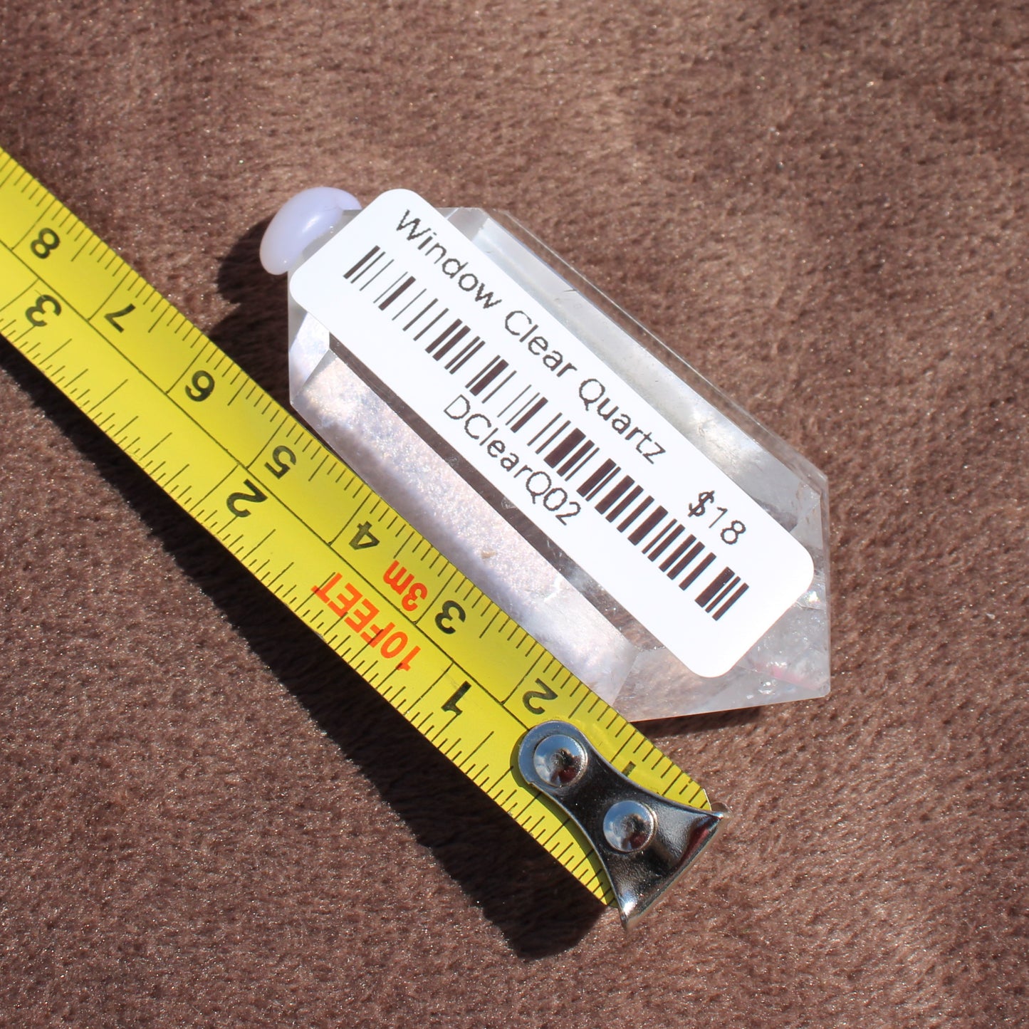 High Quality Clear Quartz crystal from Different Branches LLC shown with measuring tape for size reference