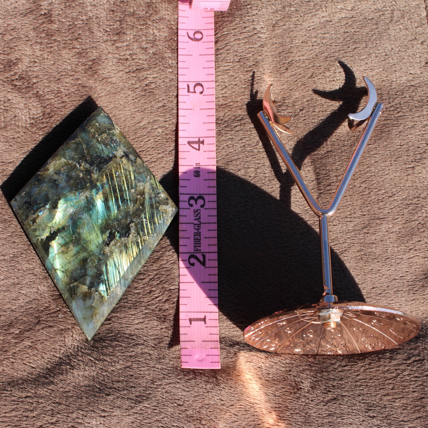 Labradorite Diamond Crystal with Unique Patterns Next to Measuring Tape for Size Reference