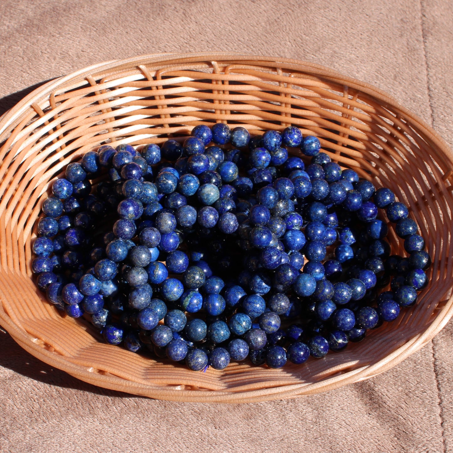 Lapis Lazuli Bracelet displayed in a woven basket showcasing its vibrant blue color and natural texture