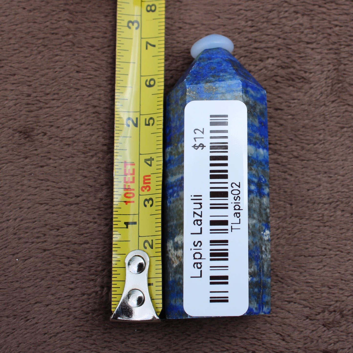 Lapiz Lazuli Tower crystal next to measuring tape showing size by Different Branches LLC