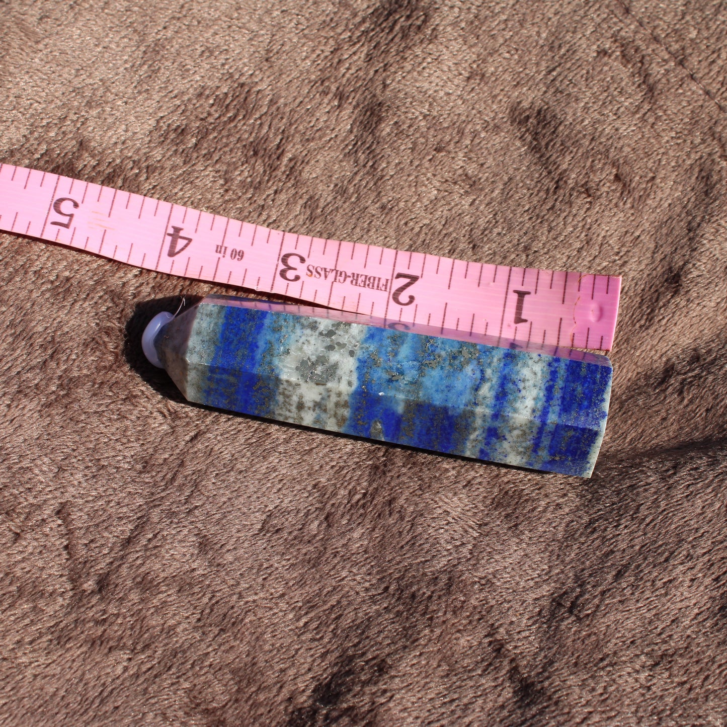 Lapis Tower Collection crystal displayed with a measuring tape to show size and detail