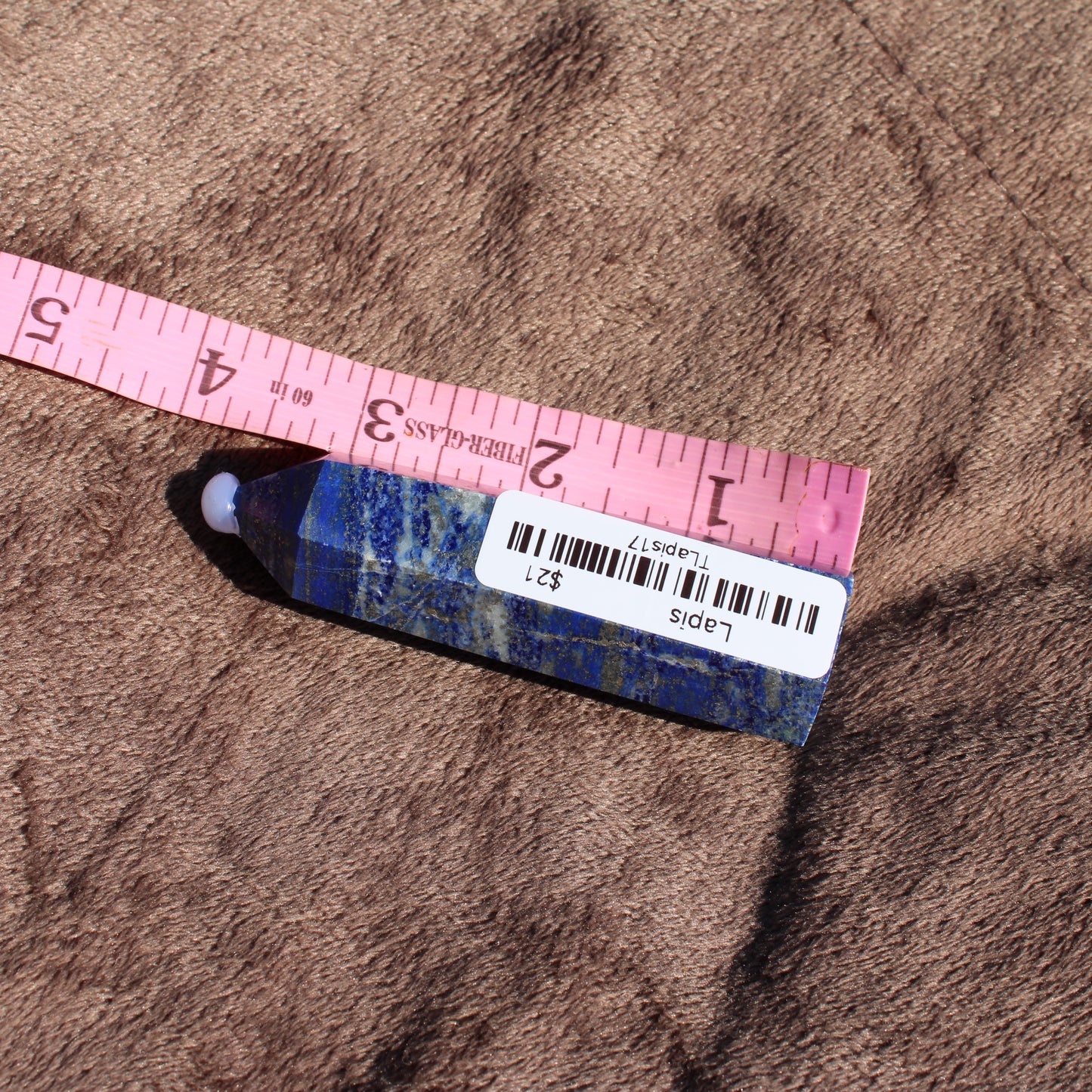 Lapis Tower Collection Crystal Piece with Rich Blue Color and Unique Patterns on a Brown Background