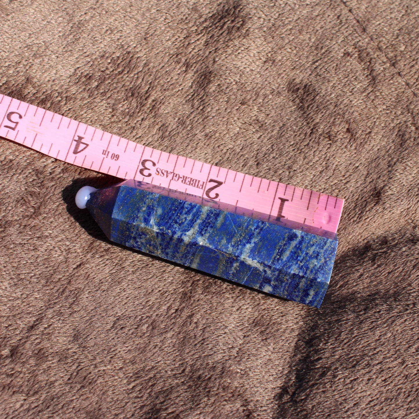 Lapis Tower Collection crystal displayed with measuring tape for size reference
