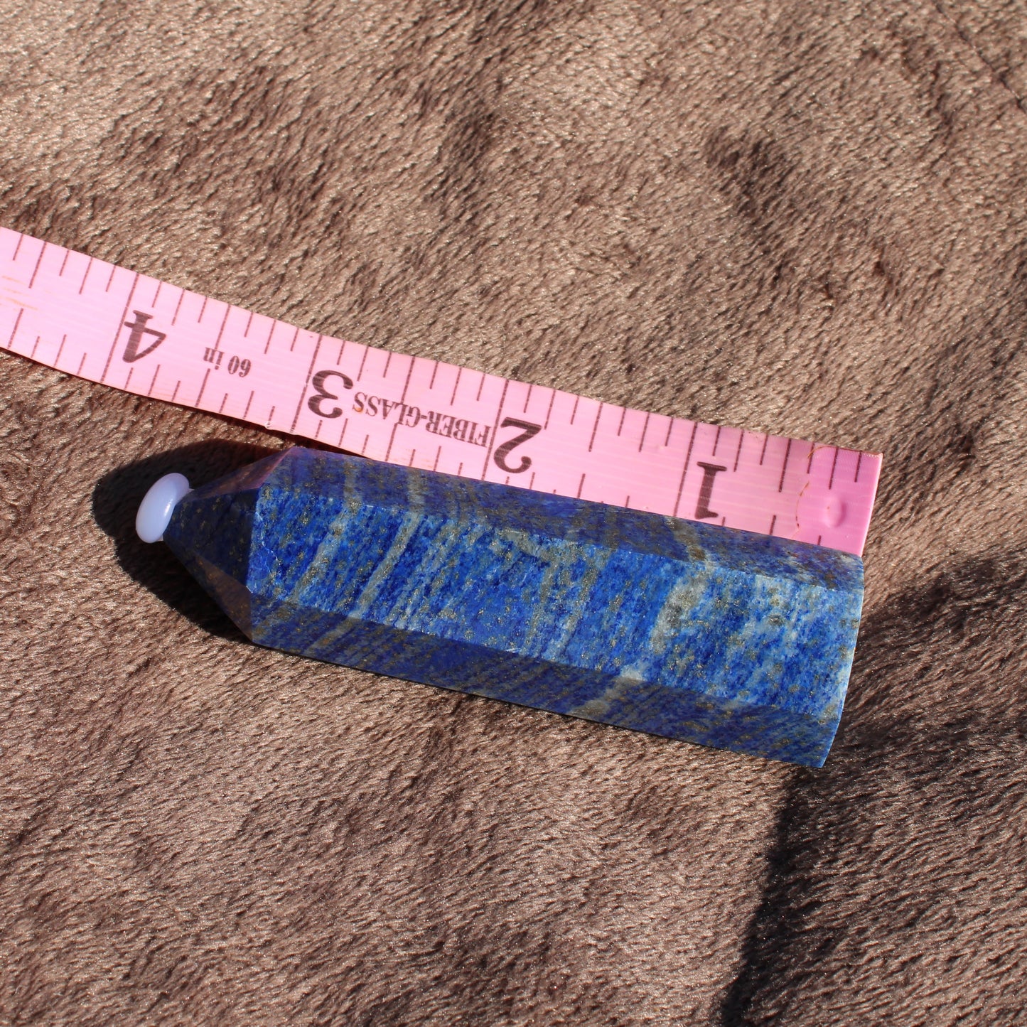 Lapis Tower Collection crystal with vibrant blue and gold accents, measuring approximately four inches long