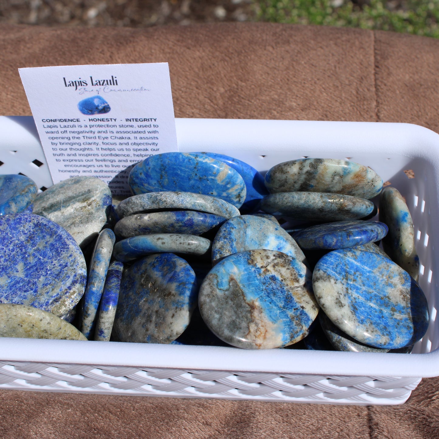 A collection of Lapis worry stone - Autumn 2025 in various blue and gray designs arranged in a basket