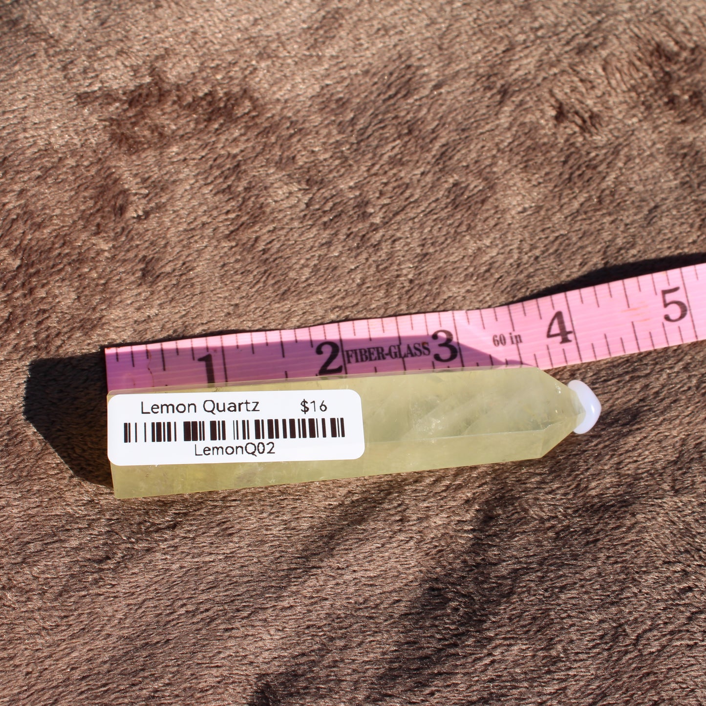 Lemon Quartz Tower displayed with a measuring tape for size reference, ideal for crystal collectors