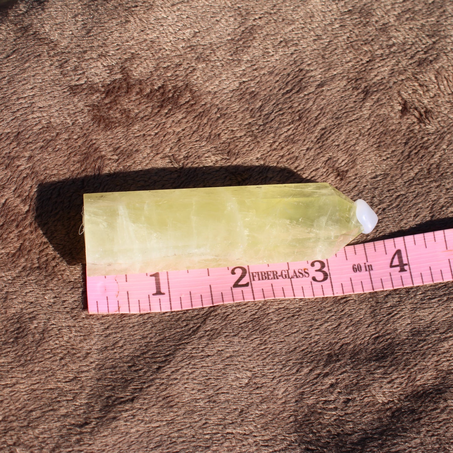 Lemon Quartz Tower in a polished finish resting on a soft surface for crystal enthusiasts